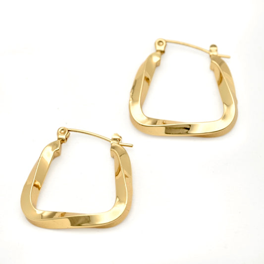 A pair of medium sized irregularly square U shaped hoop earrings with a swirling edgy design displayed on white surface