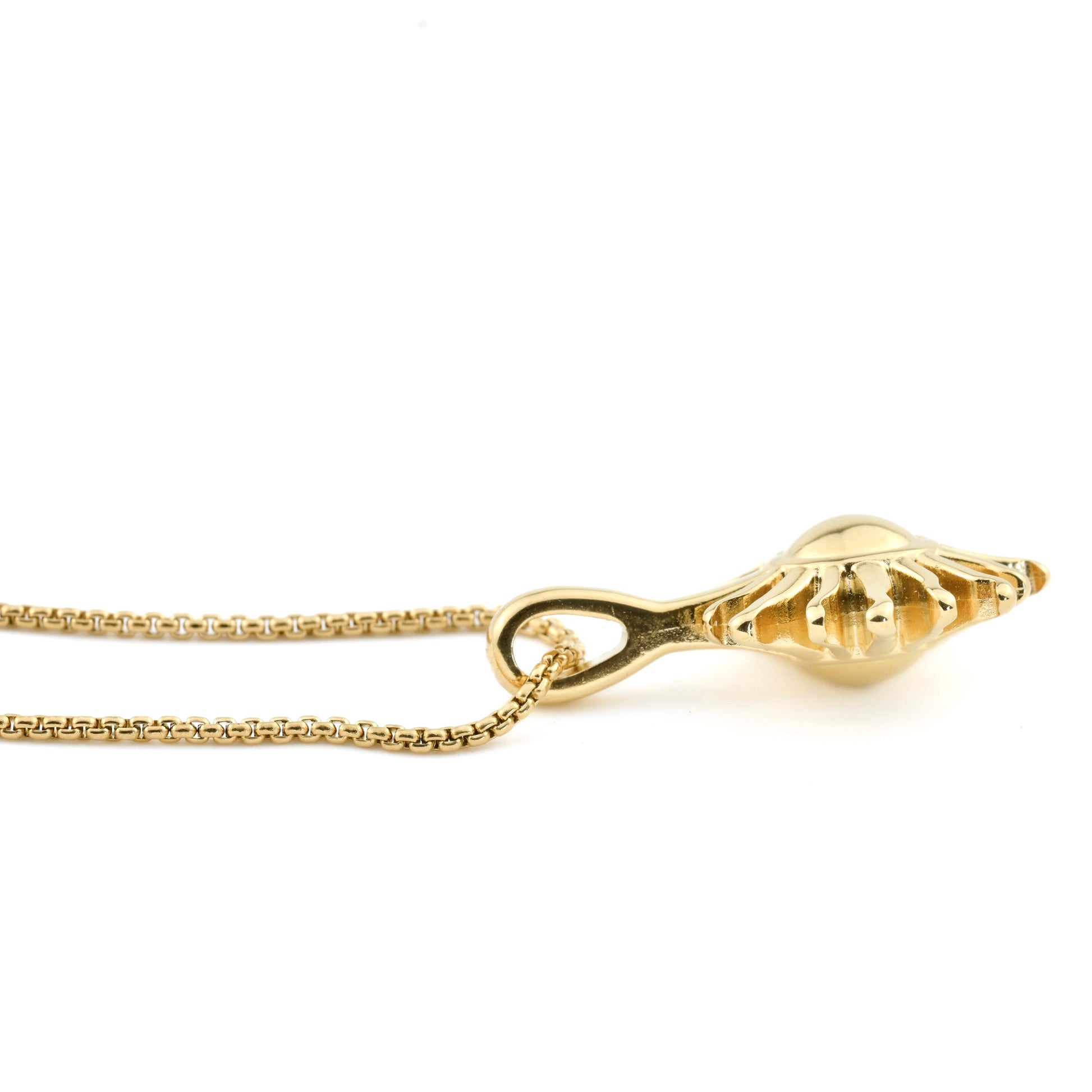 Close-up  side of the Gold sun pendant showing the double sided feature on a white background