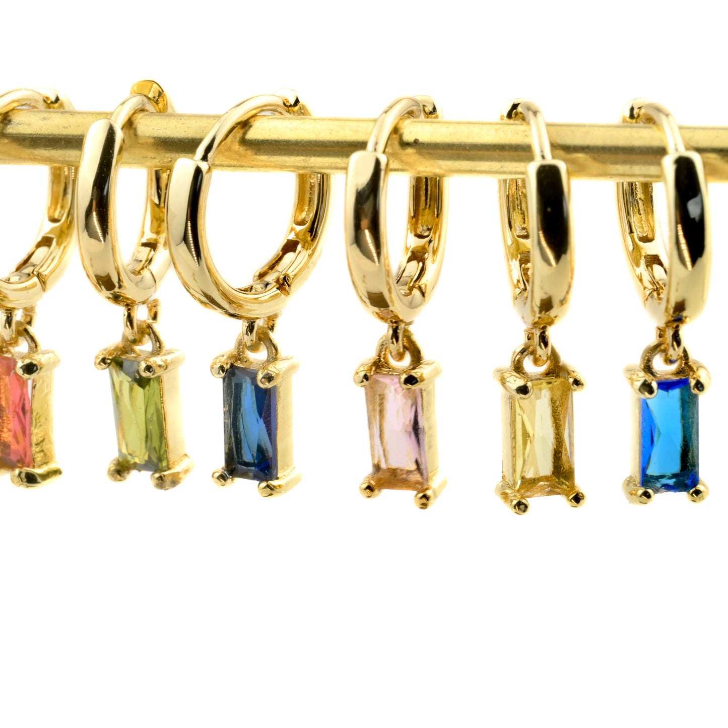 Gold huggie hoop earrings with diamond charms on a white background