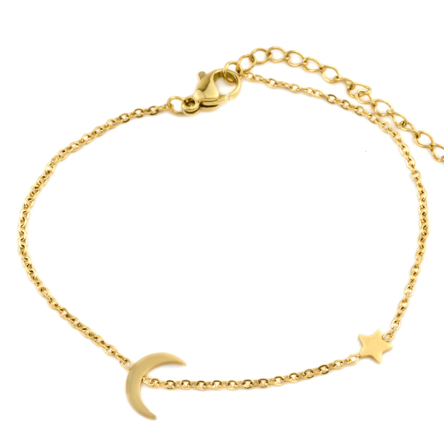 Gold bracelet with moon and star charms on a white background