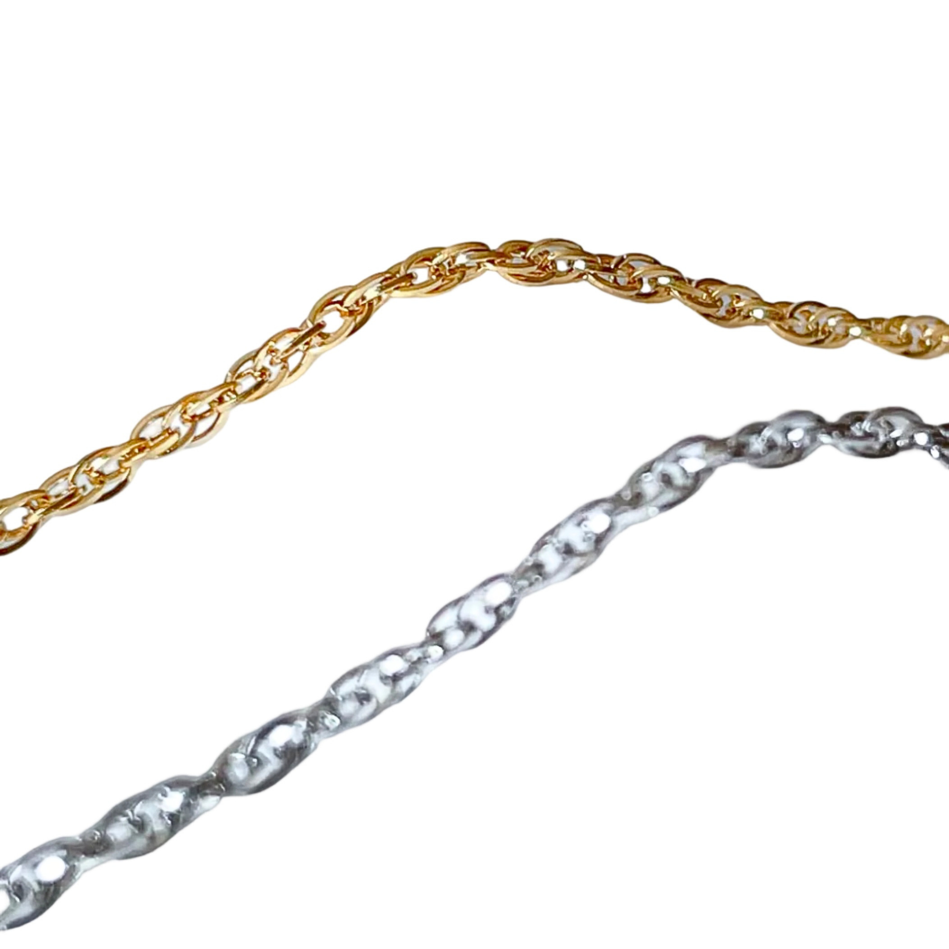 Gold and silver twist chain ankle bracelets on a white background