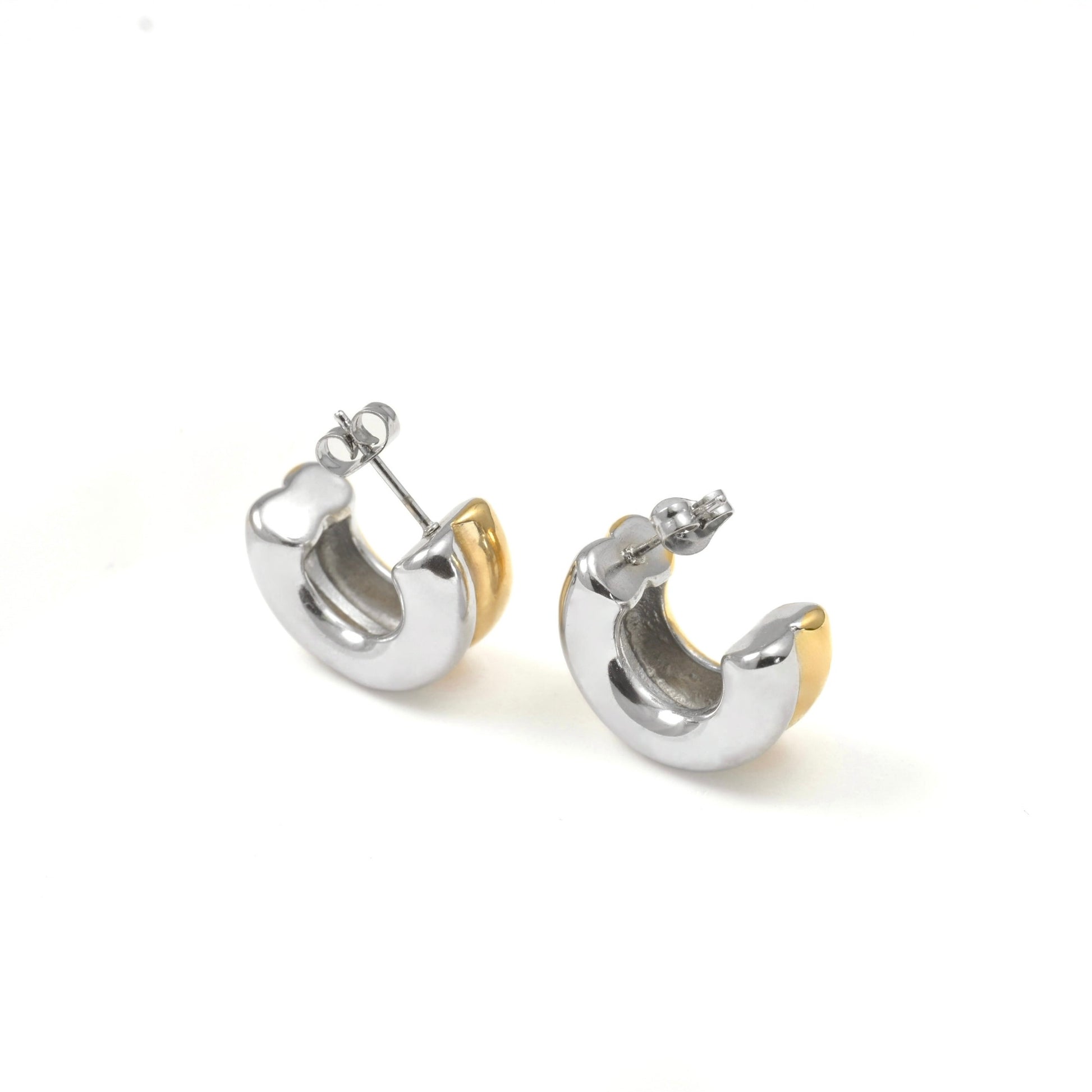 Pair of bold hoop earrings,half gold half silver, on a white background