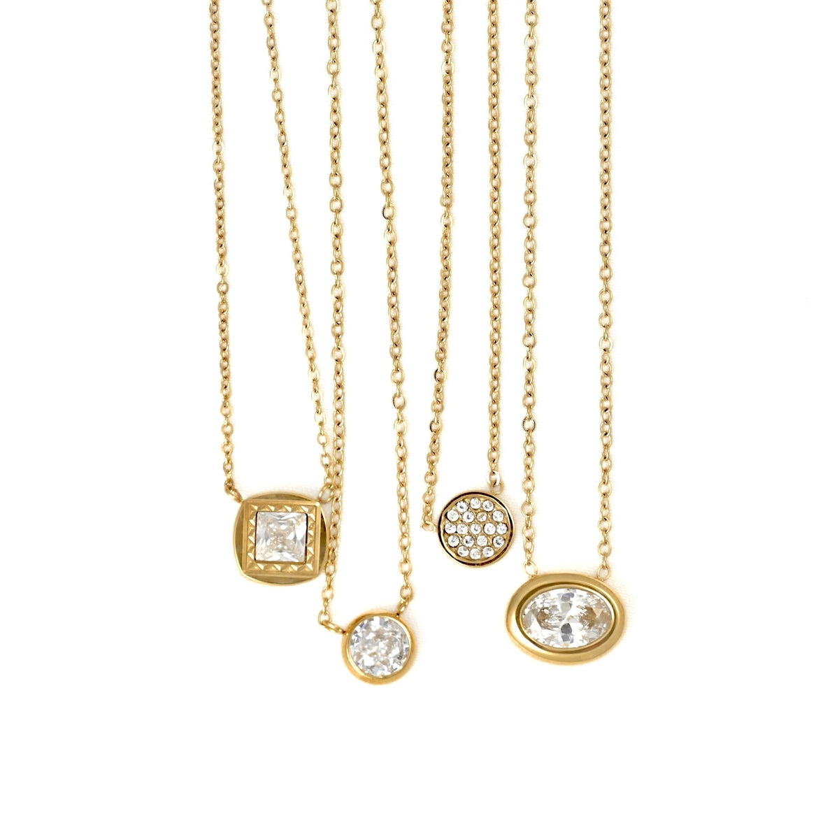 Five gold chain necklaces with different pendant designs, including a square bezel, a round pavé disc, and an oval bezel, all set with clear gemstones, displayed against a solid white background.