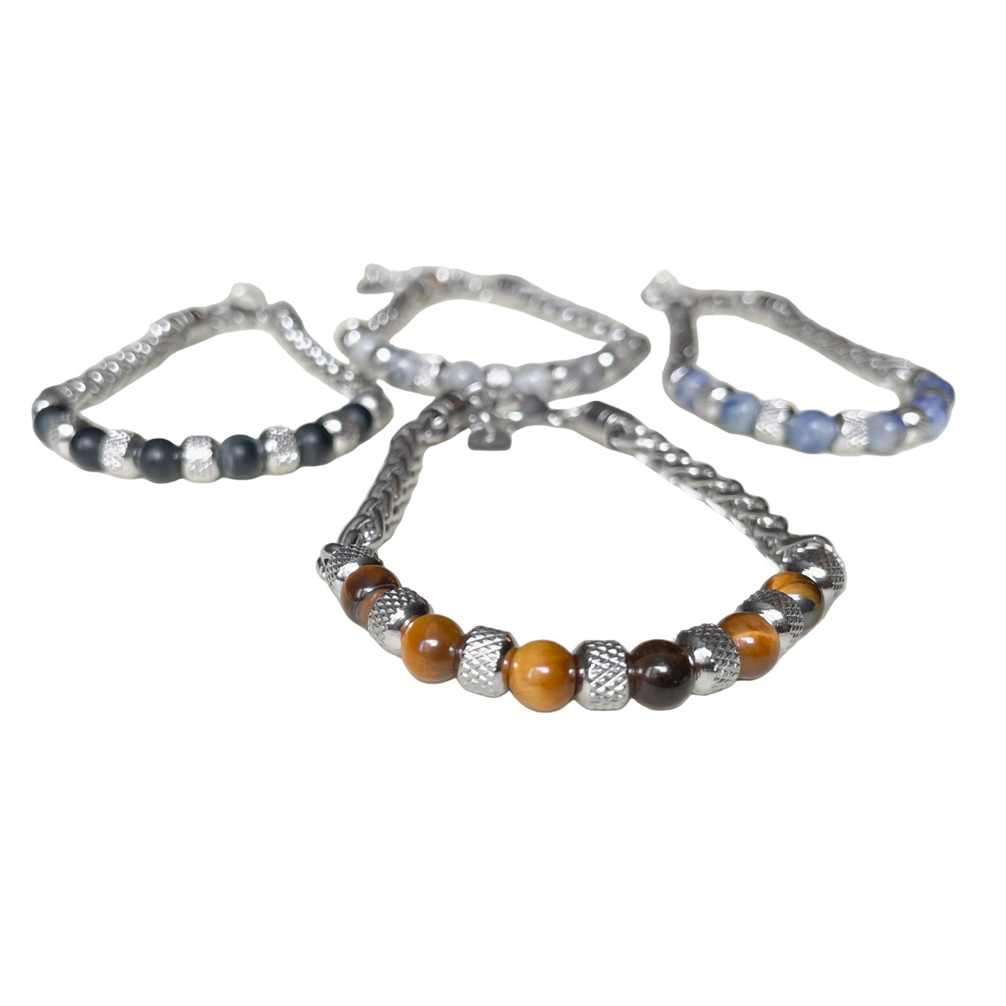 Set of silver bracelets with beaded and metallic designs on a white background