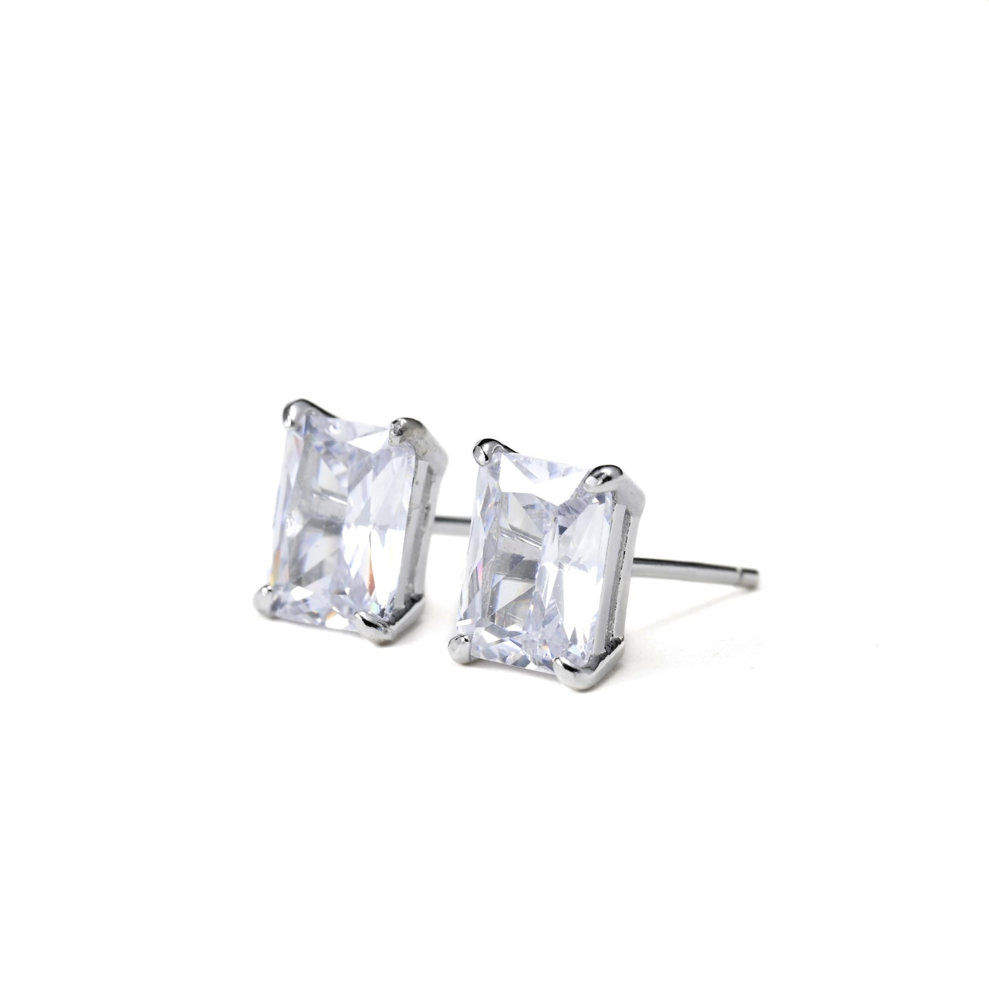 Pair of radiant CZ stud earrings with rectangular clear gemstones on a white background