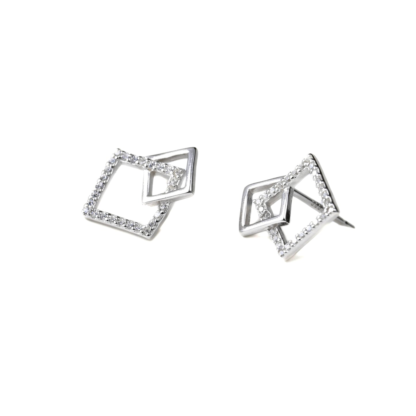 Pair of silver geometric earrings on a white background