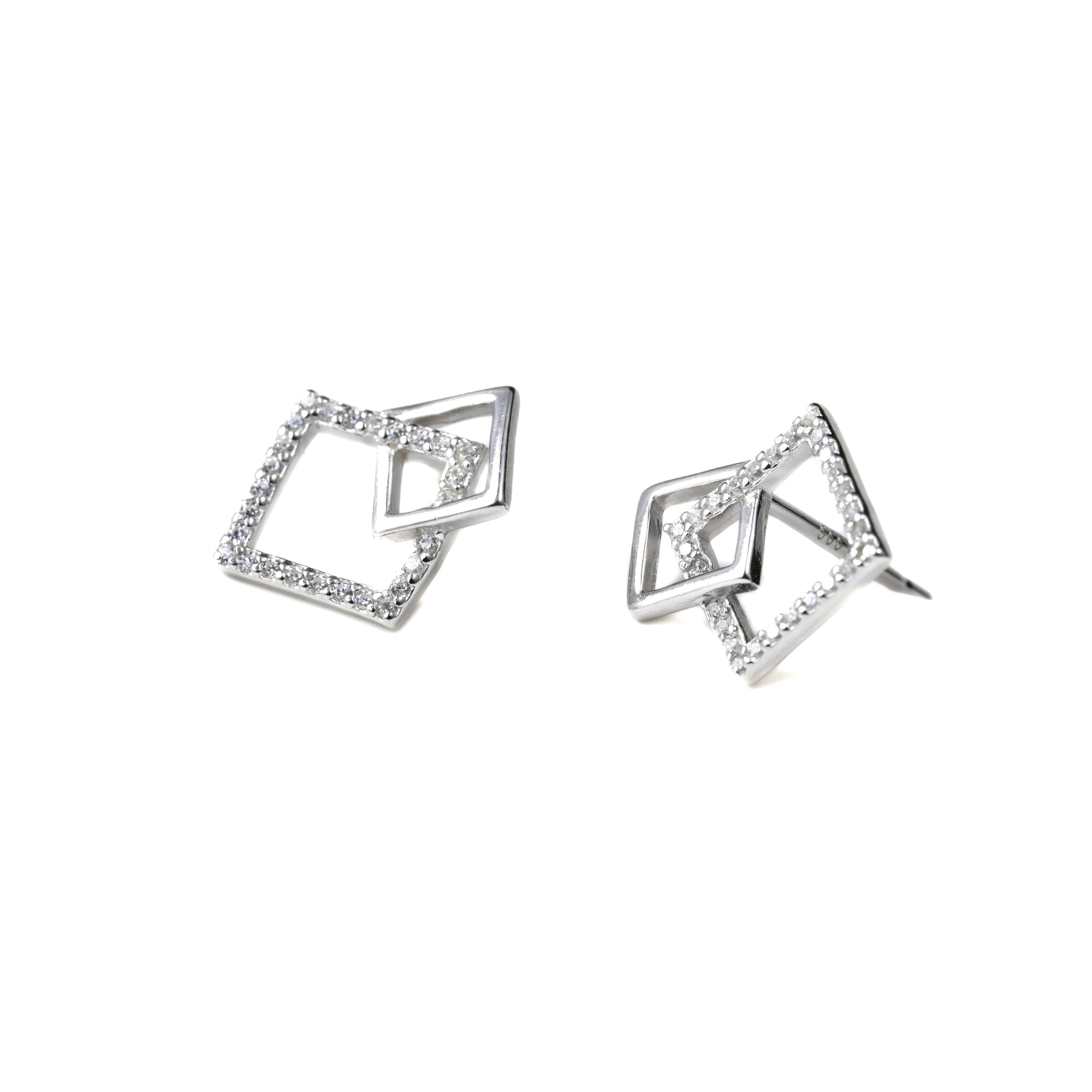 Pair of silver geometric earrings on a white background