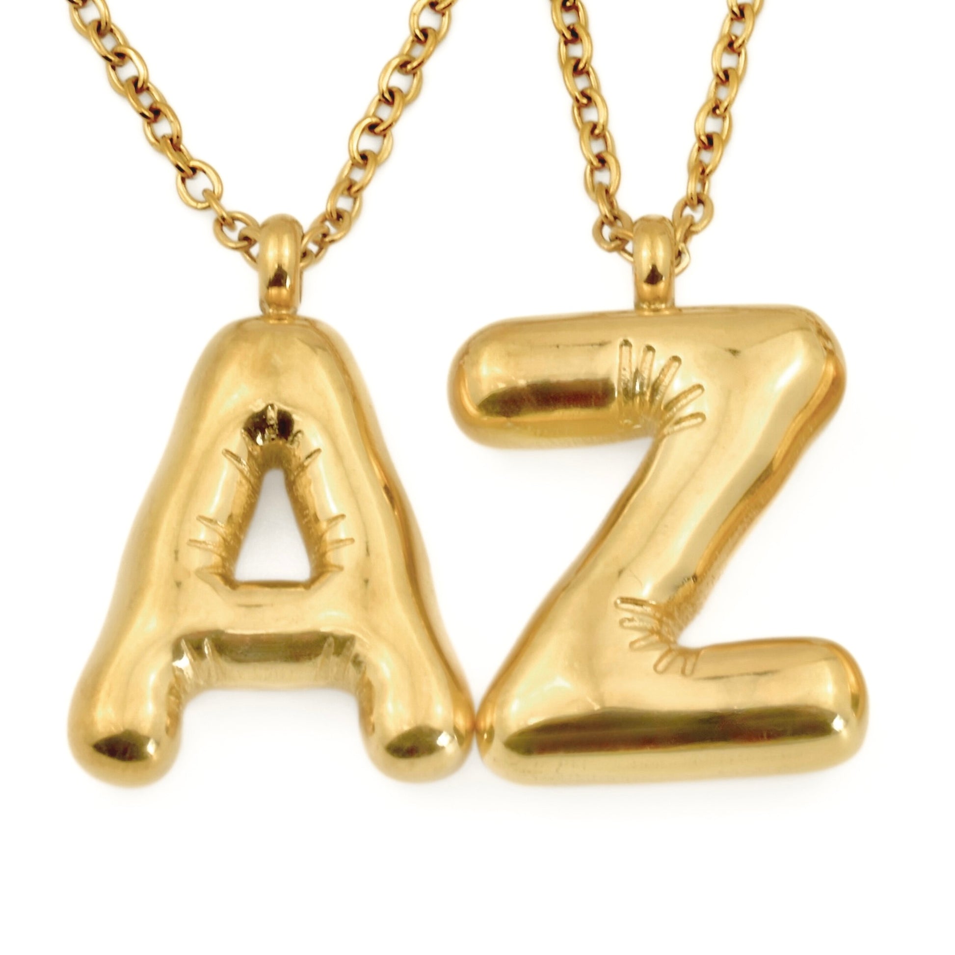 Gold balloon pendant necklaces with 'A' and 'Z' pendants on a white background