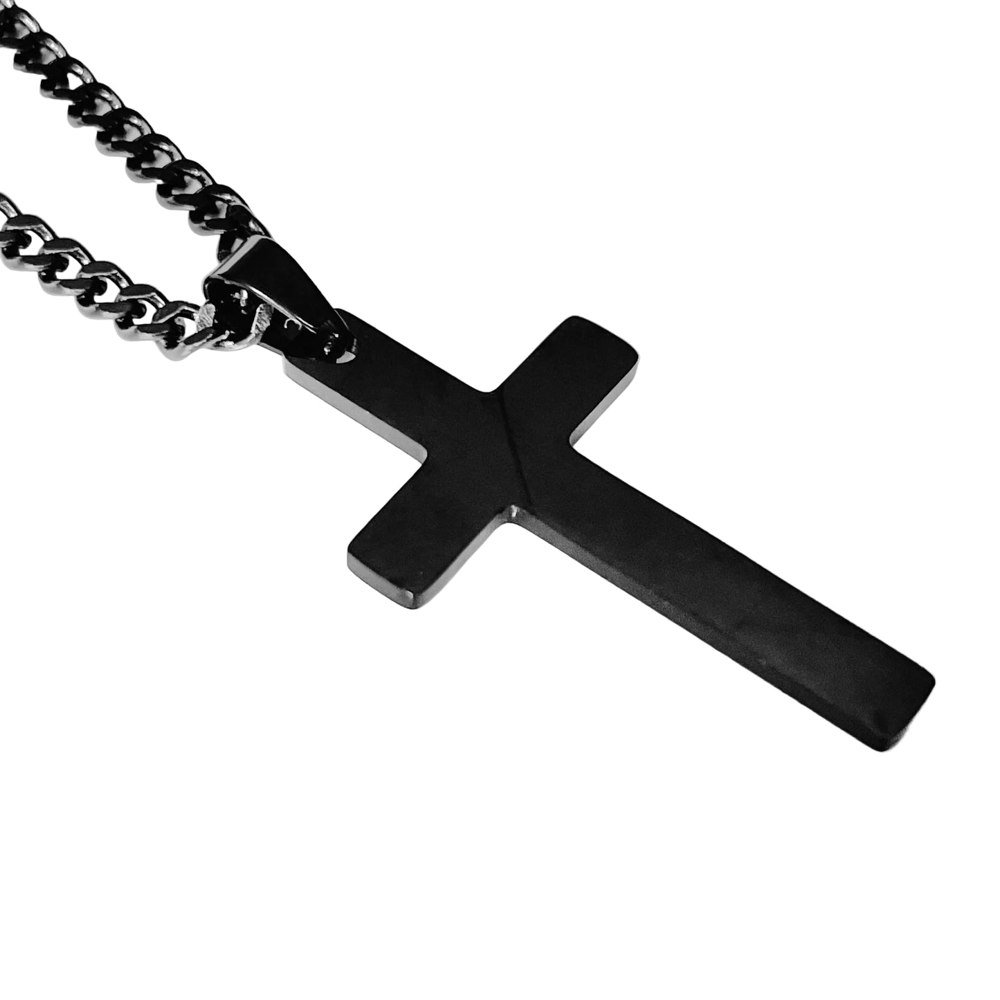 Black cross pendant on a curb chain against a white background