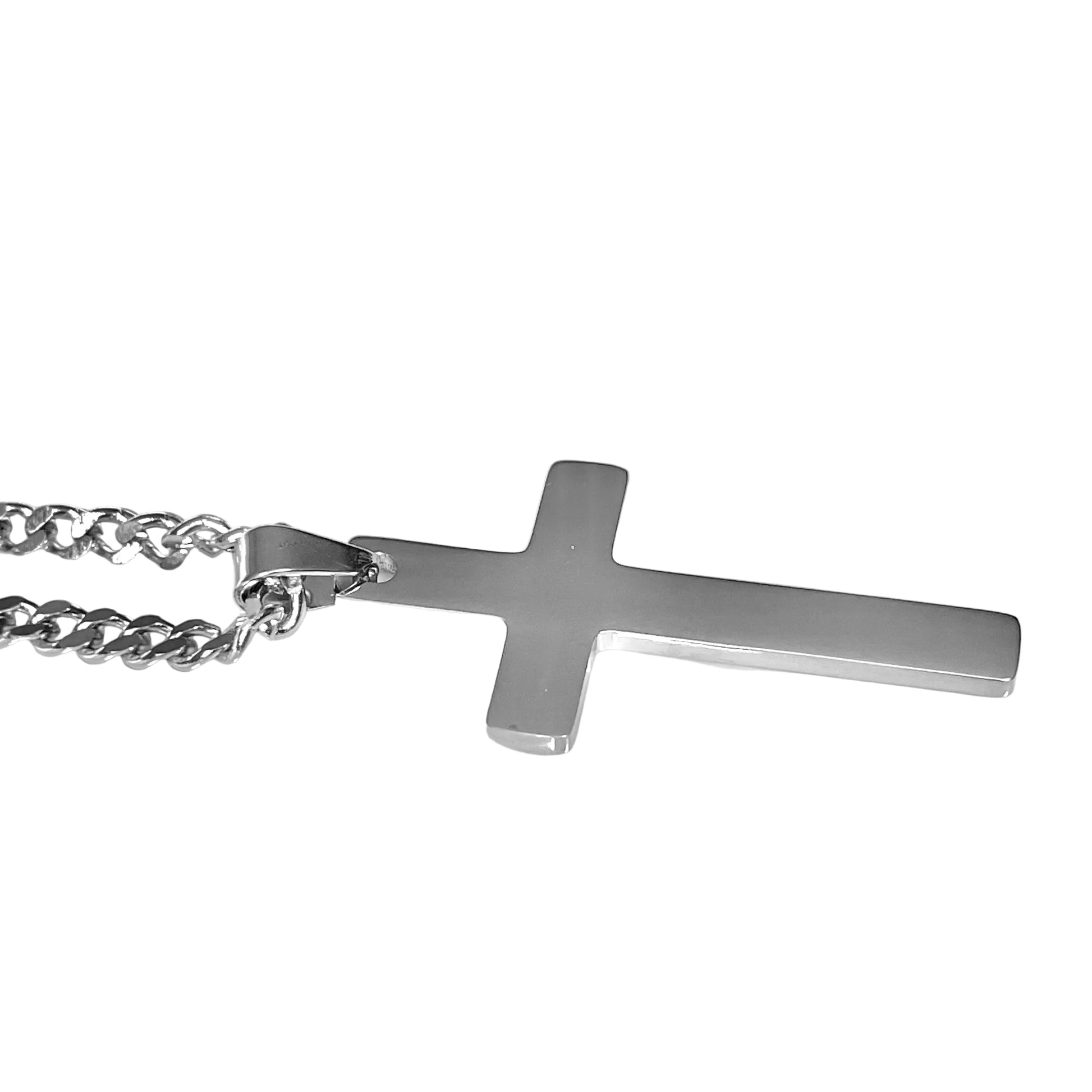 Side close up view of silver cross pendant on a chain against a white background