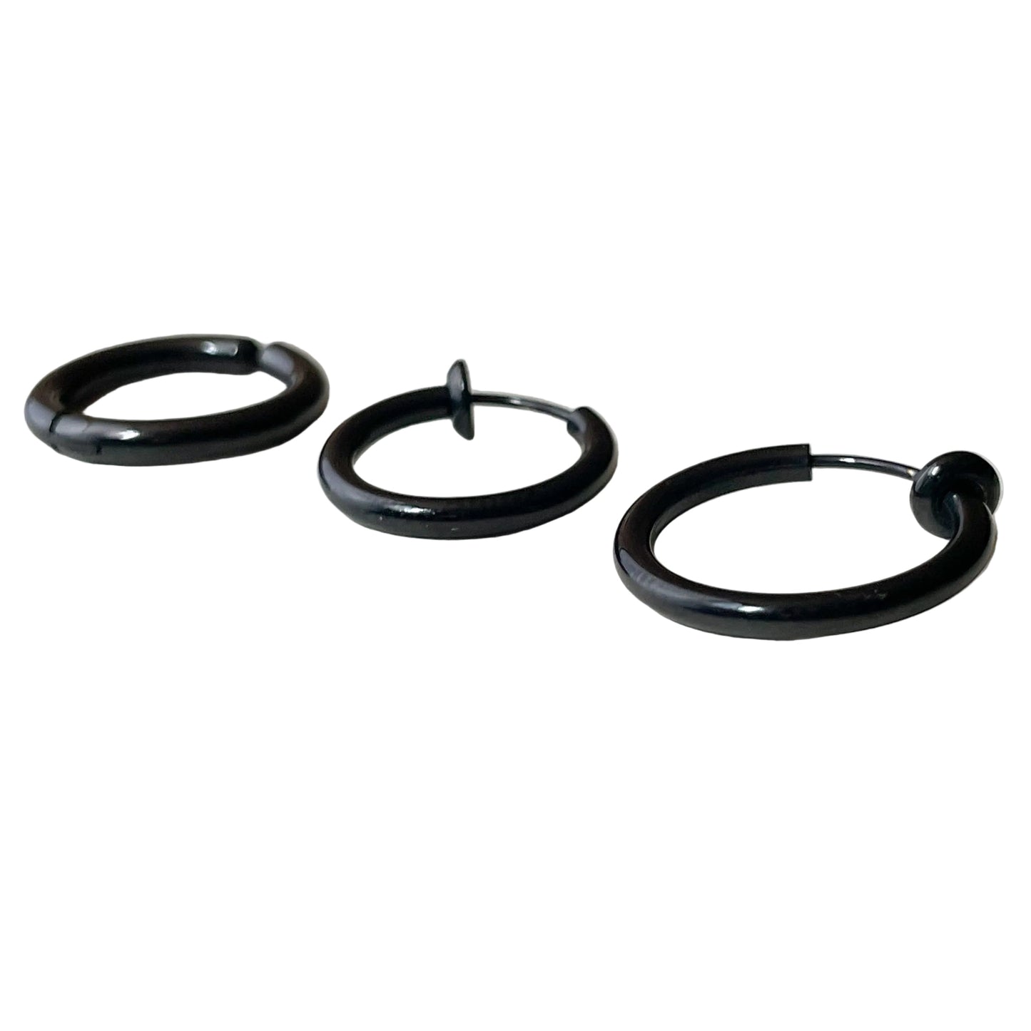 Black hoop earrings on a white surface