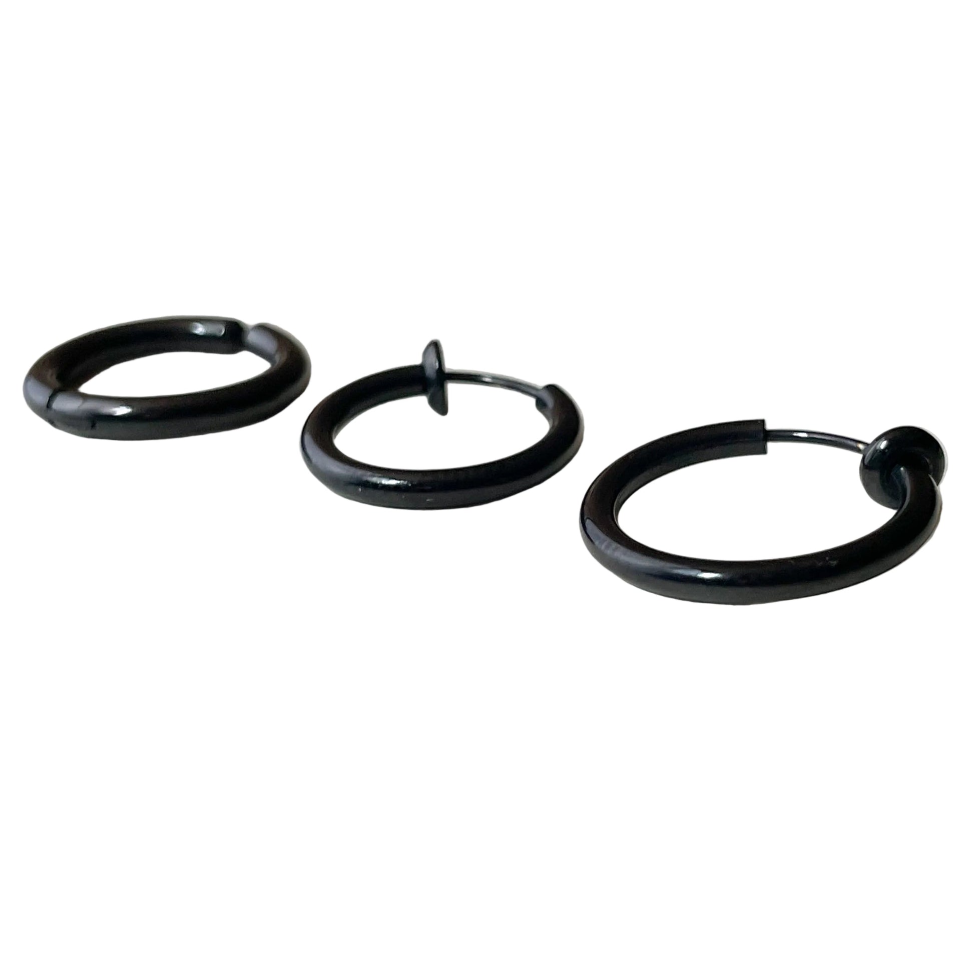 Black hoop earrings on a white surface