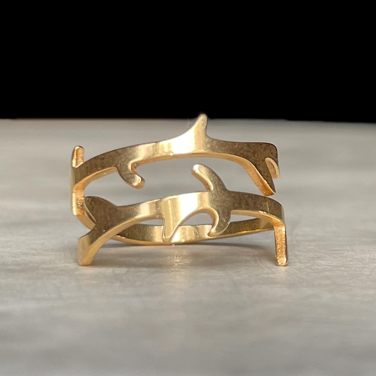 Gold tree ring on a light gray surface