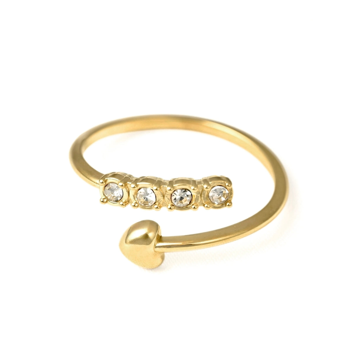 A gold open-band ring featuring four clear round-cut stones across the top and a small polished gold heart at the end, shown on a plain white background.