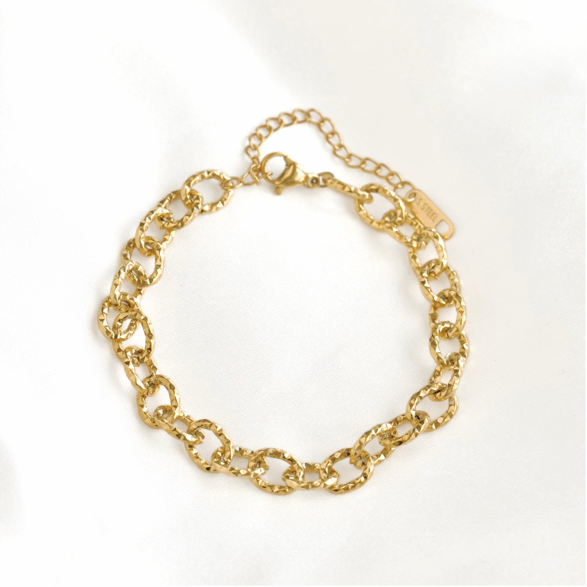 A gold chain link bracelet with a lobster clasp and extender chain, displayed on a clean white background.