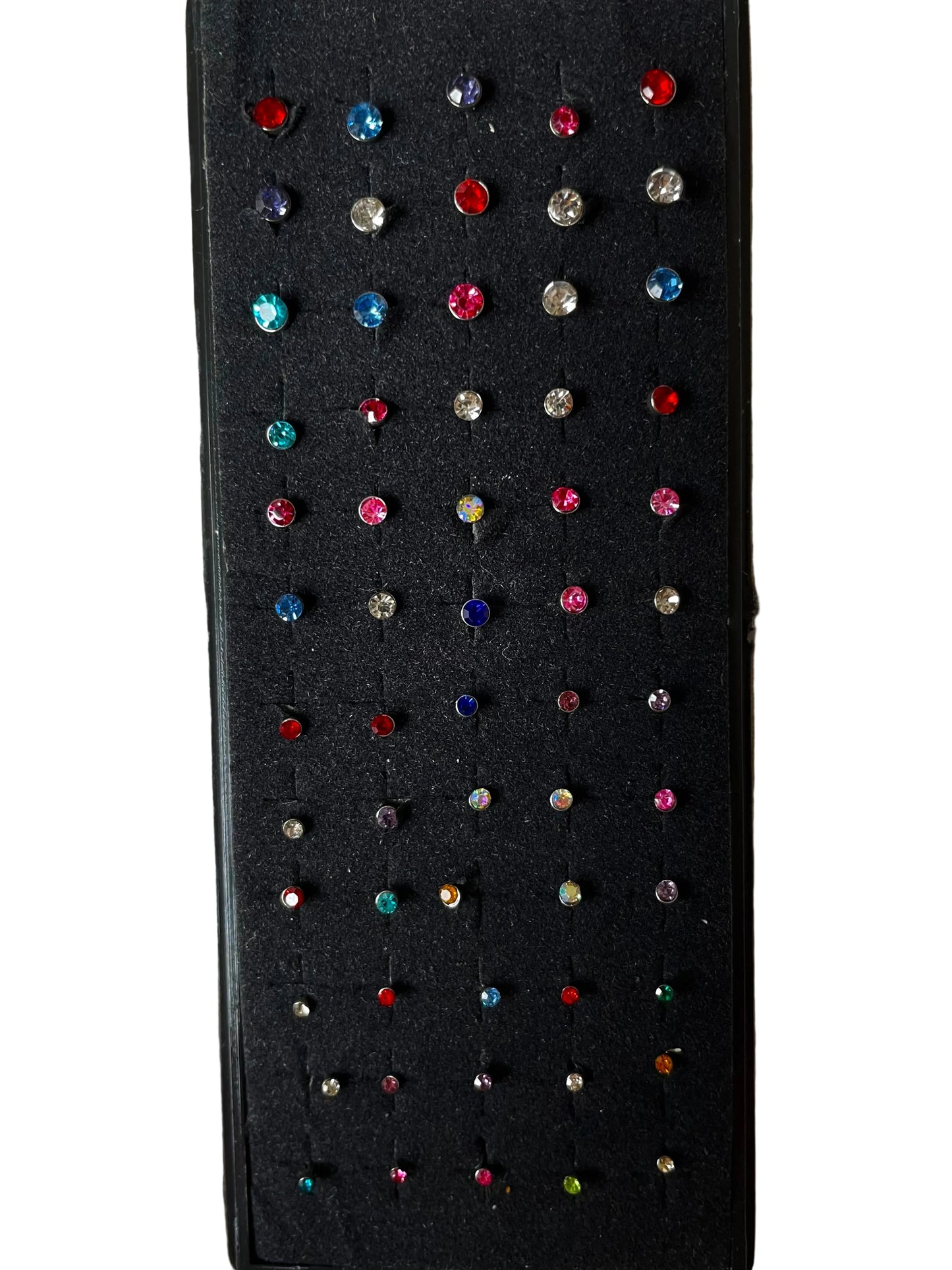 Black earring display card with colorful nose studs on a white fabric background