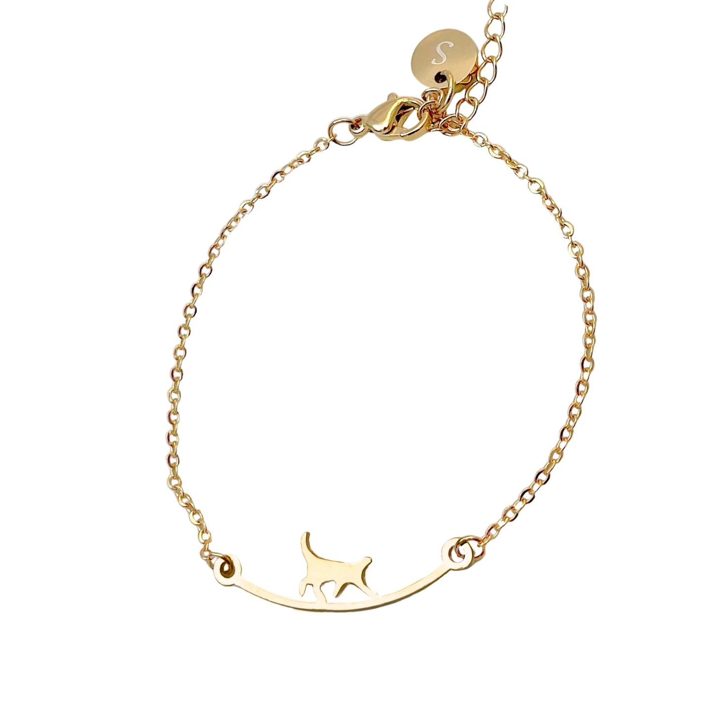 Gold bracelet with a cat silhouette walking on a log on a white background