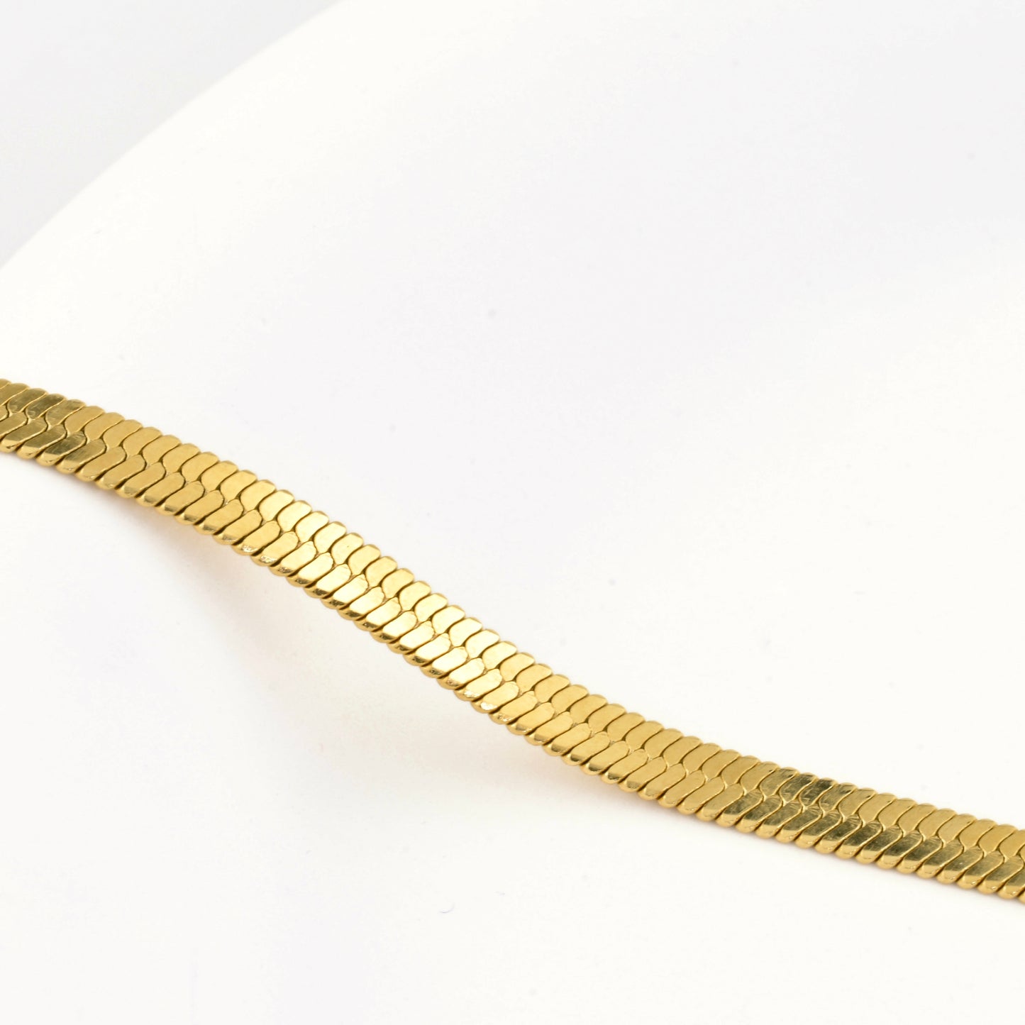 Gold  herringbone chain on a white background