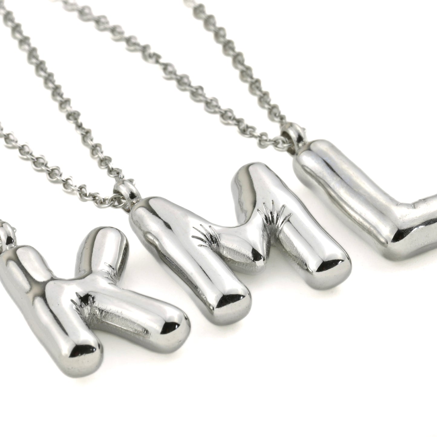 Silver molten initial necklace with letter 'K' ,'L''and M' pendants on a white background