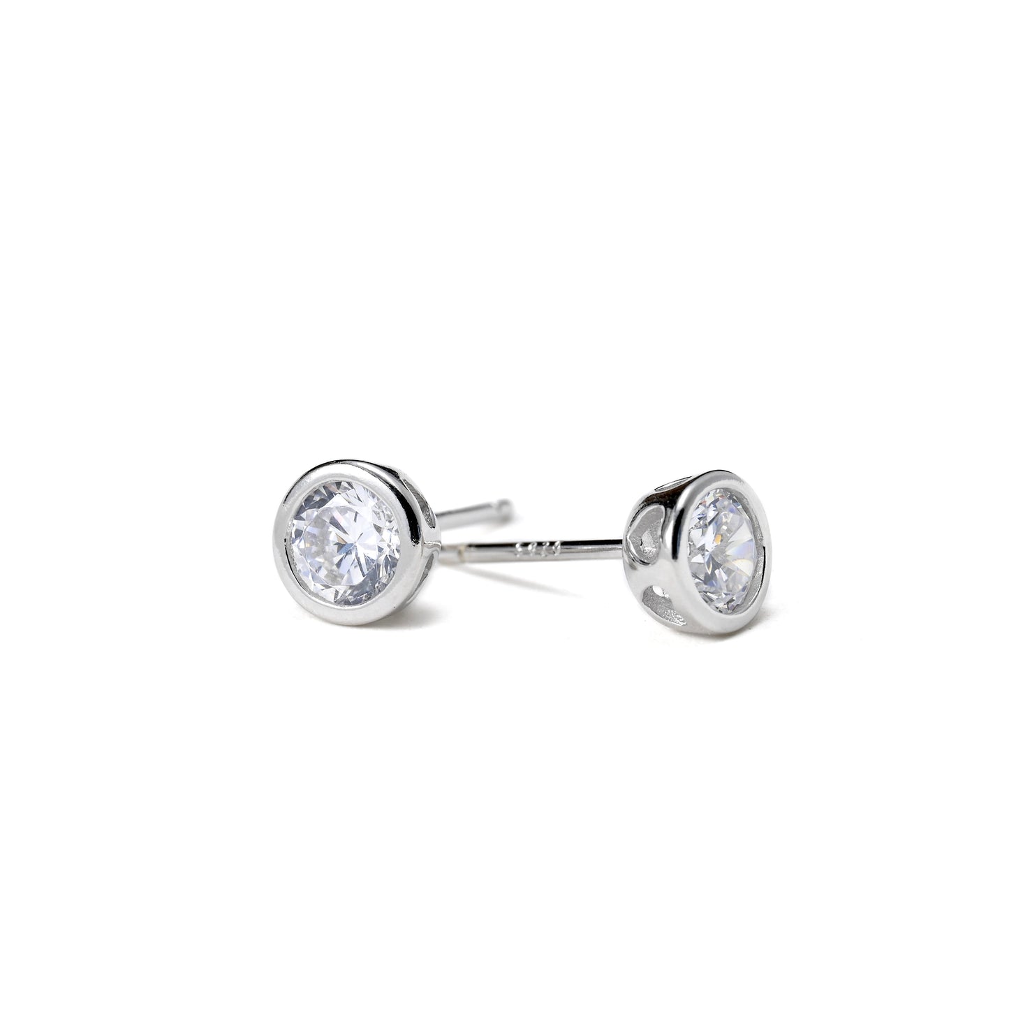 Pair of round diamond earrings with silver finish on a white background