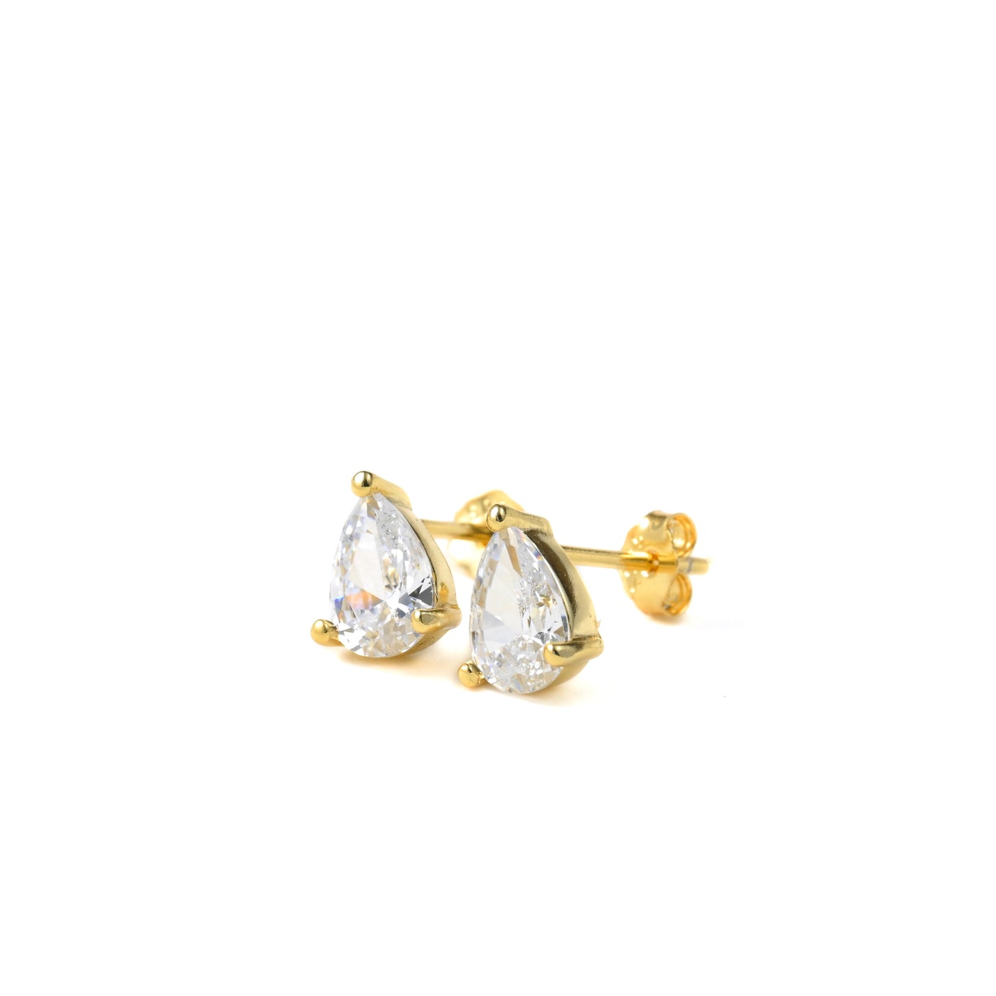 Gold teardrop earrings with clear gemstones on a white background