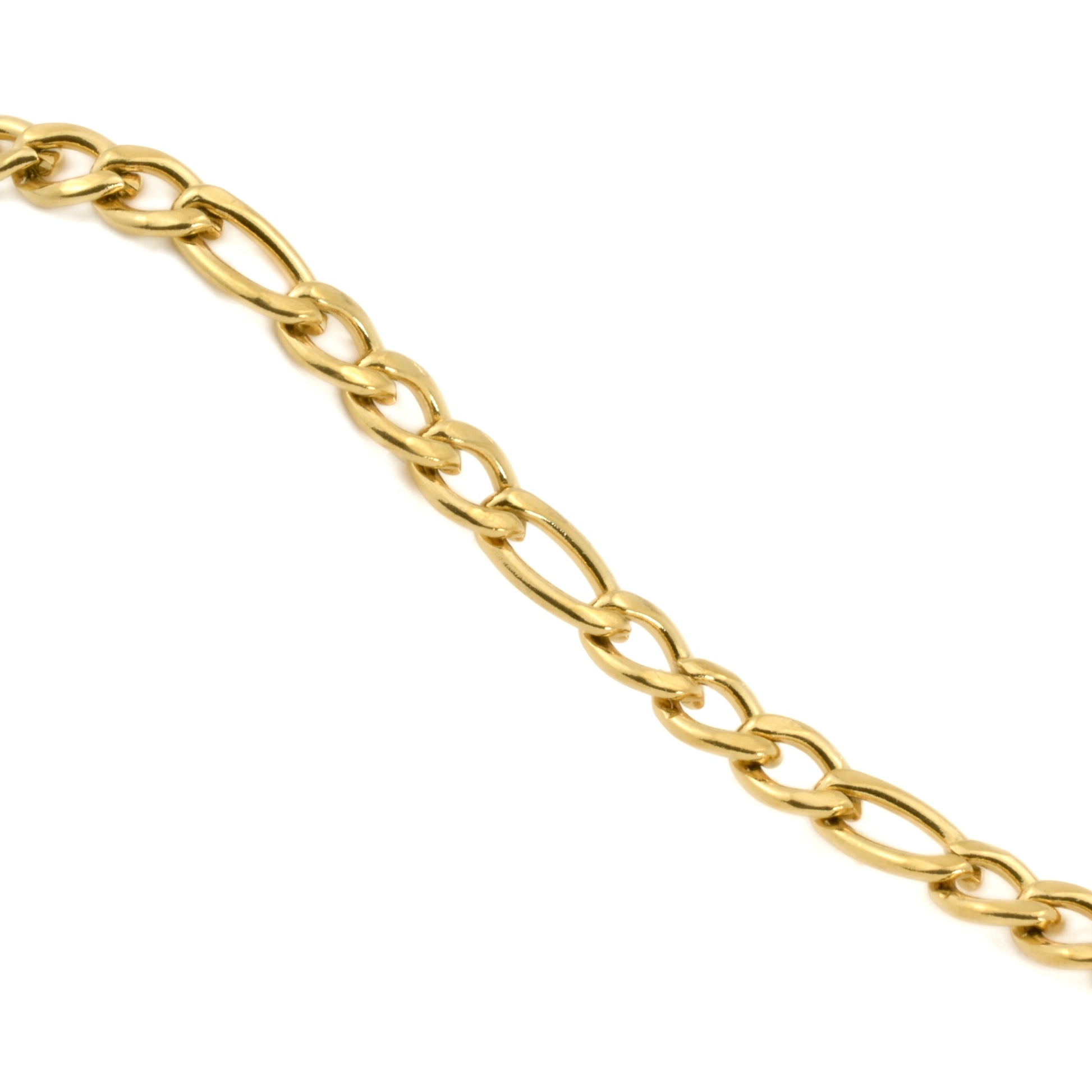 Dainty gold figaro necklace on a white background