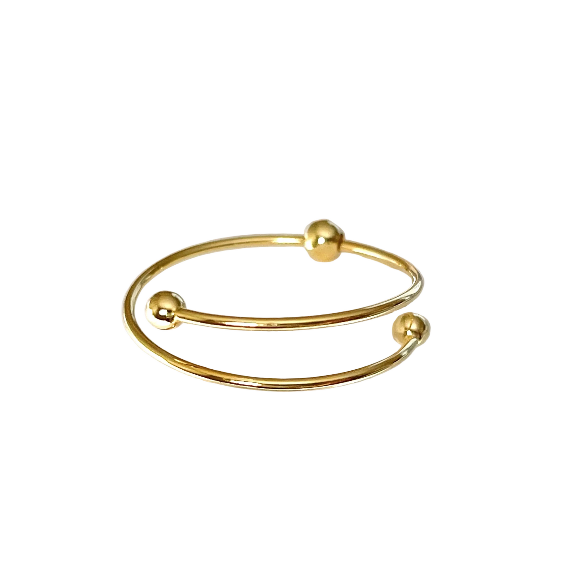 Beaded gold ring on a white background