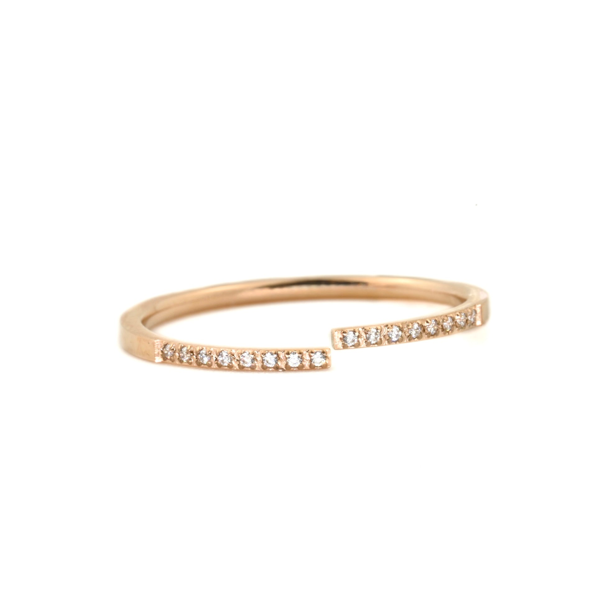 Rose gold ring with pave CZ on a white background