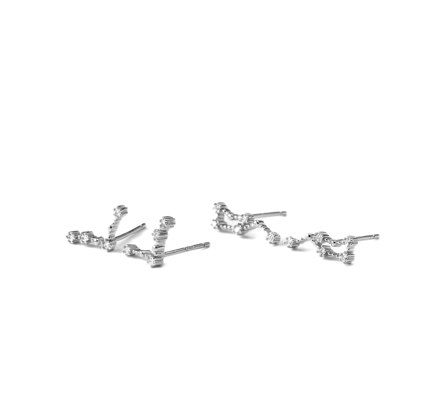 Pair of silver earrings with two constellations on a white background