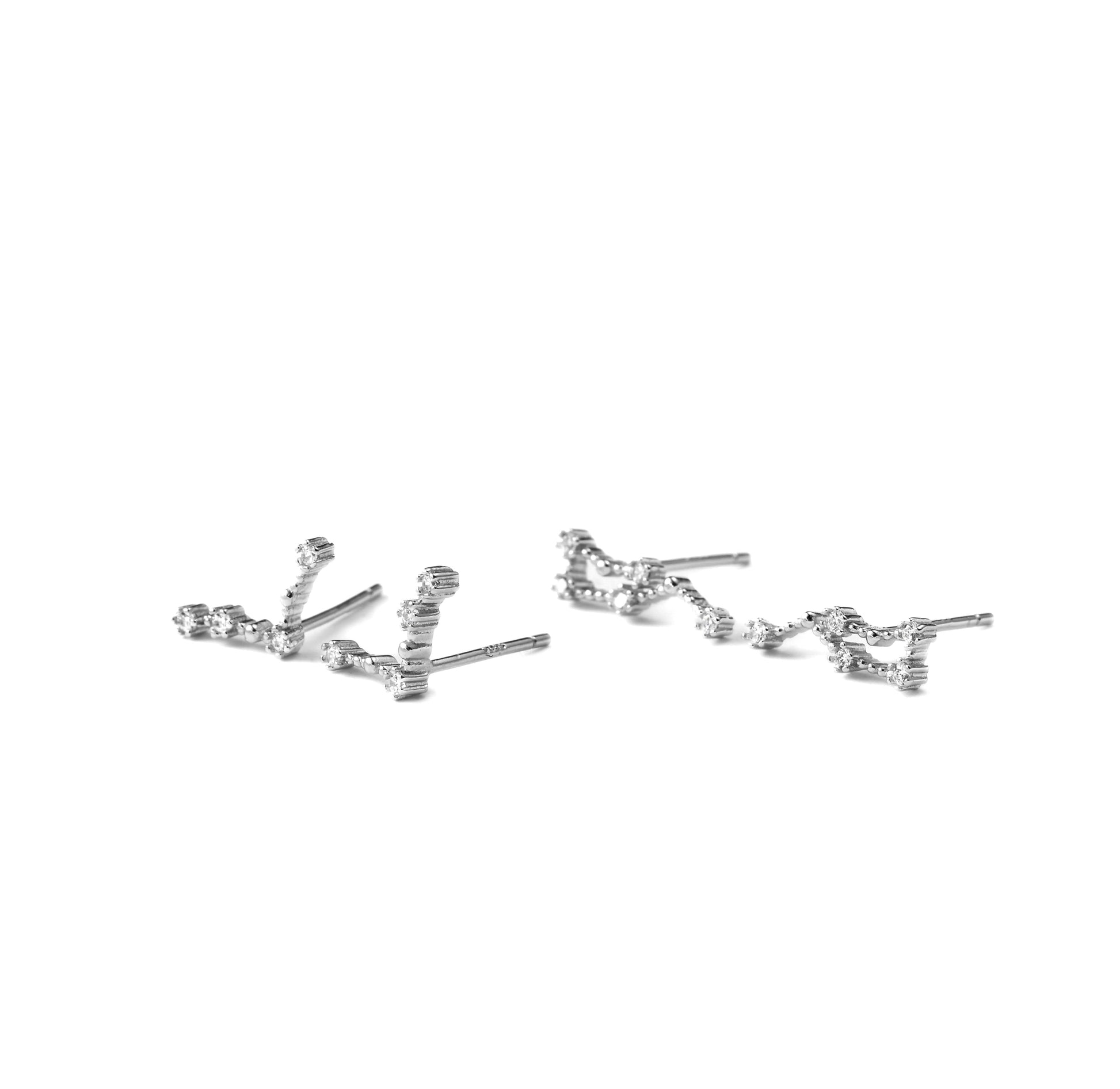 Pair of silver earrings with two constellations on a white background