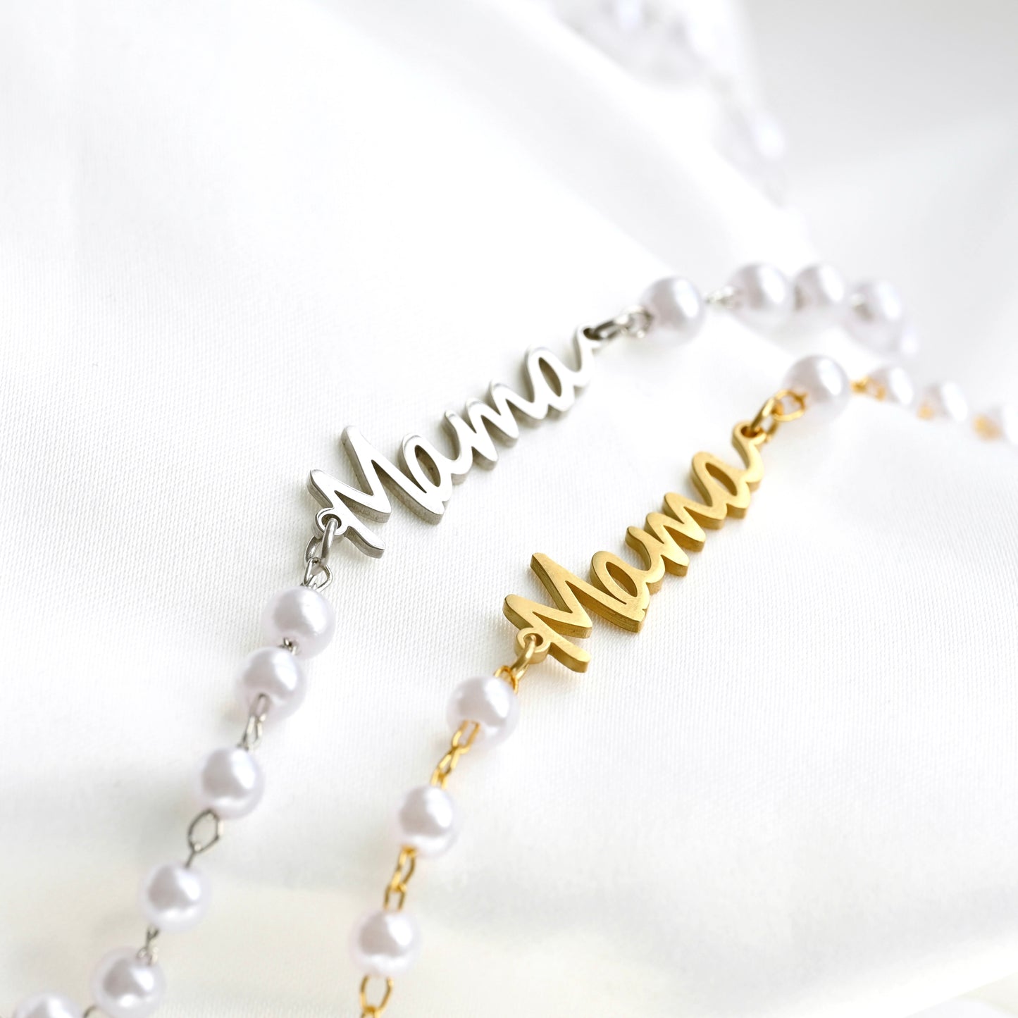 Two necklaces with 'Mama' pendants on a white background