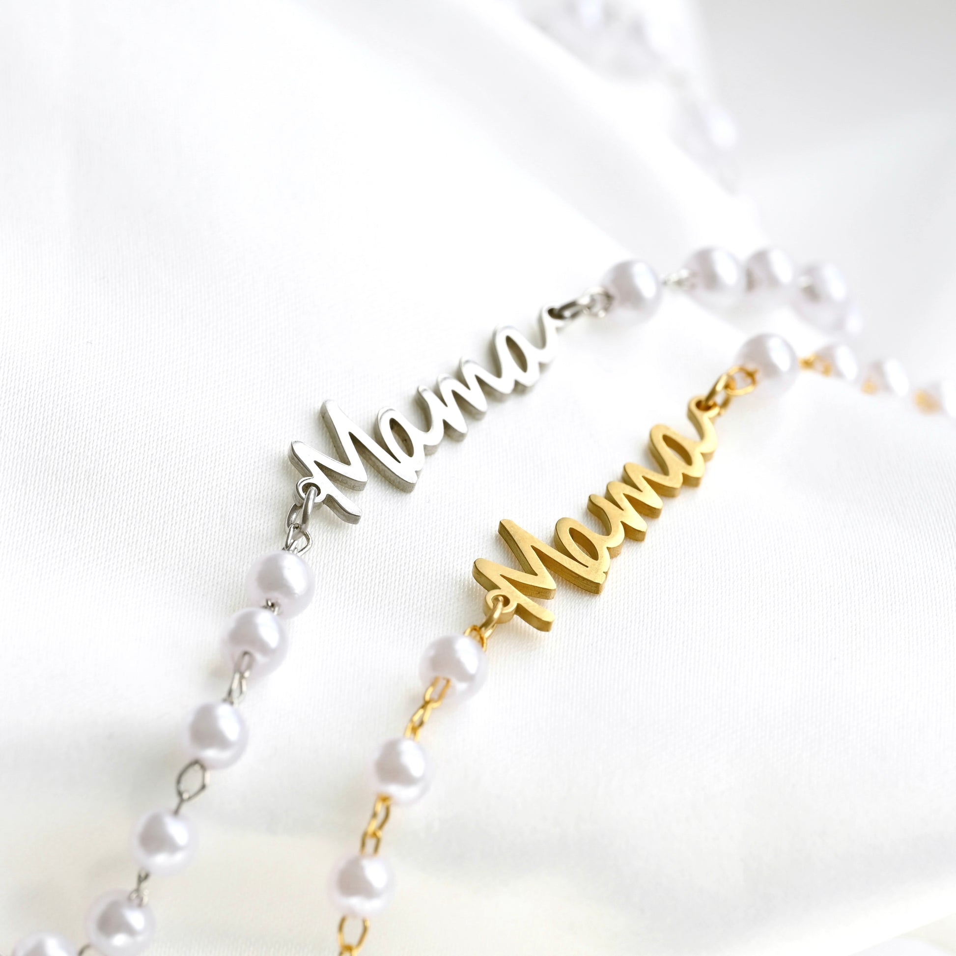 Two necklaces with 'Mama' pendants on a white background