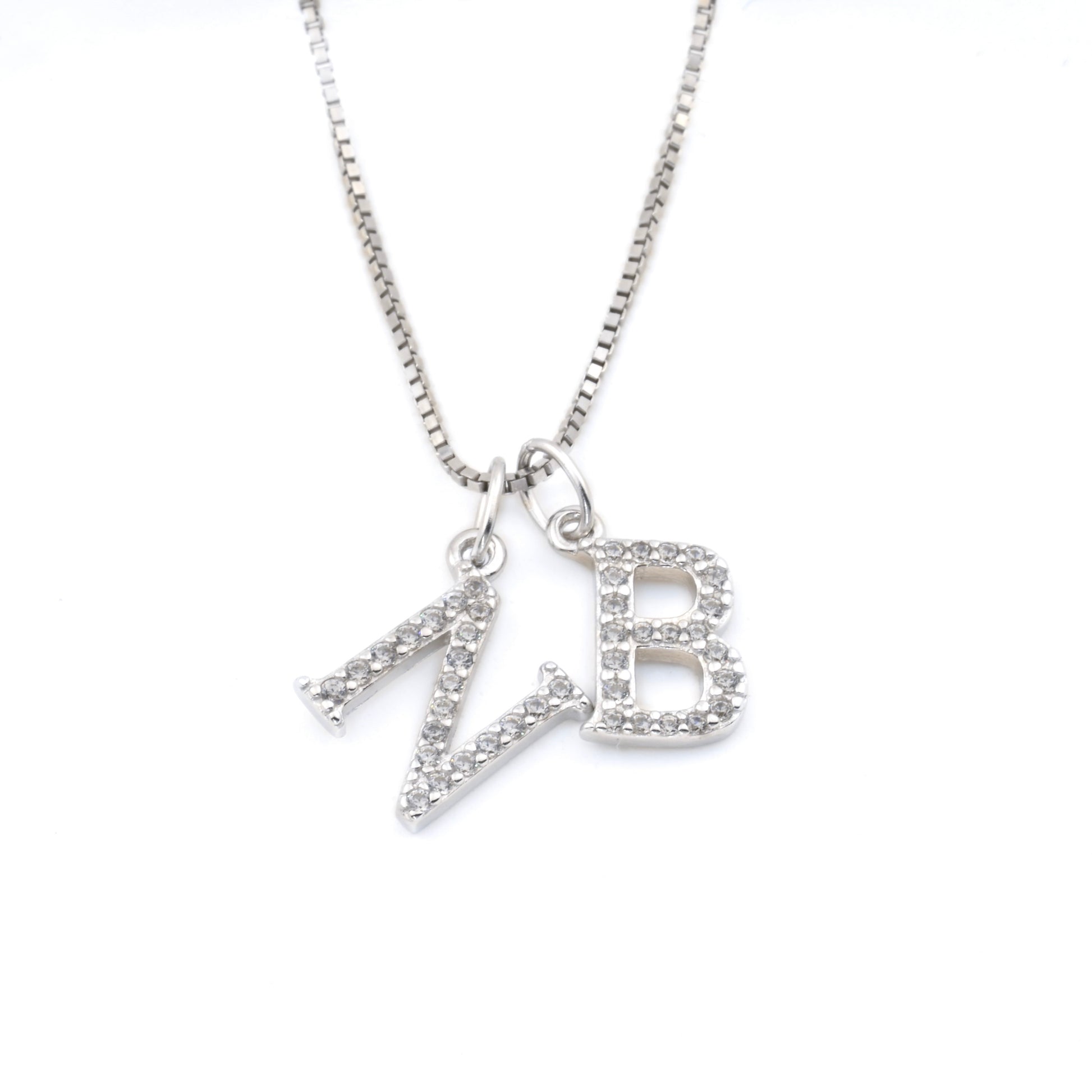 Silver box chain necklace with two initial charms on a white background