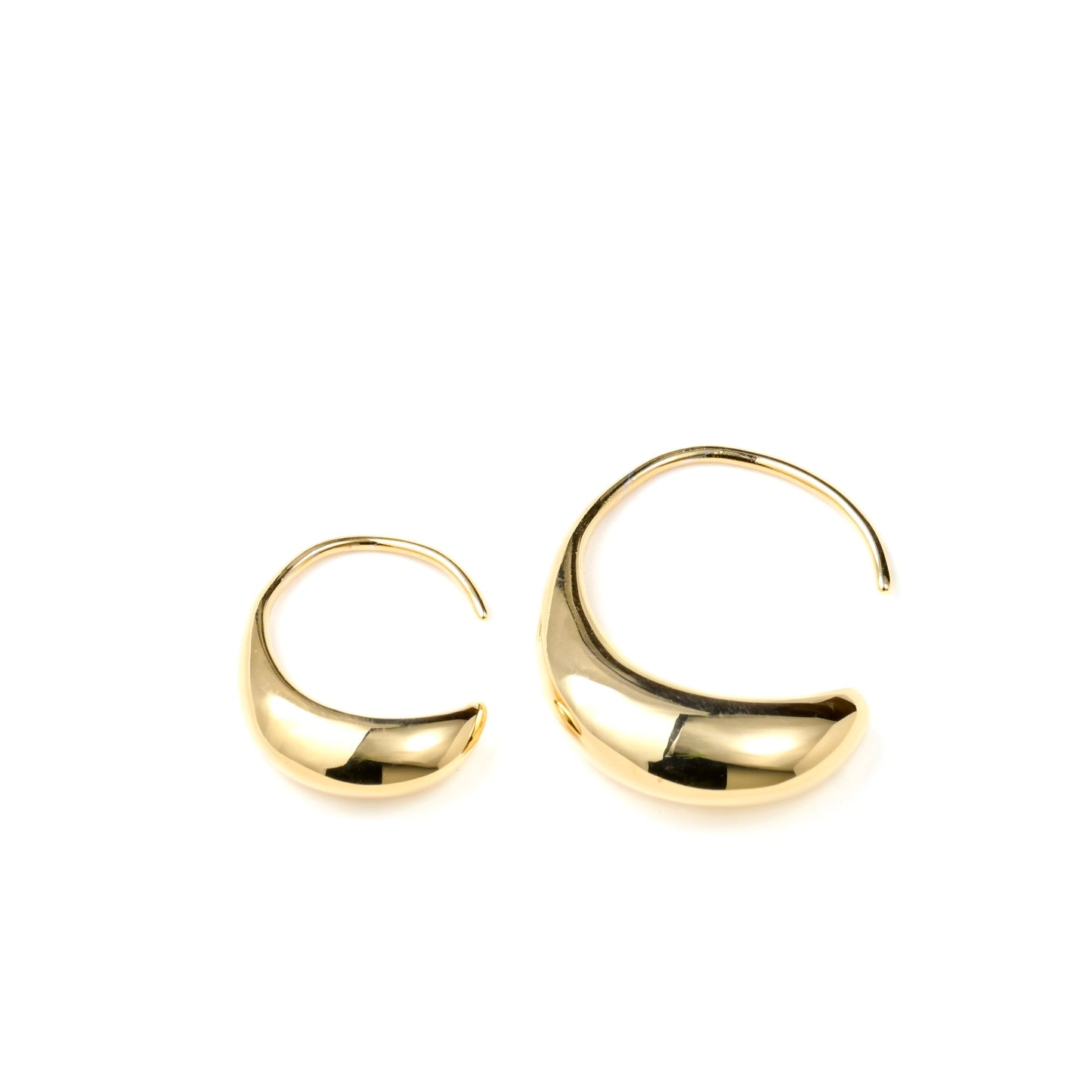 close-up of two gold drop earrings , one small and one medium, on a white background