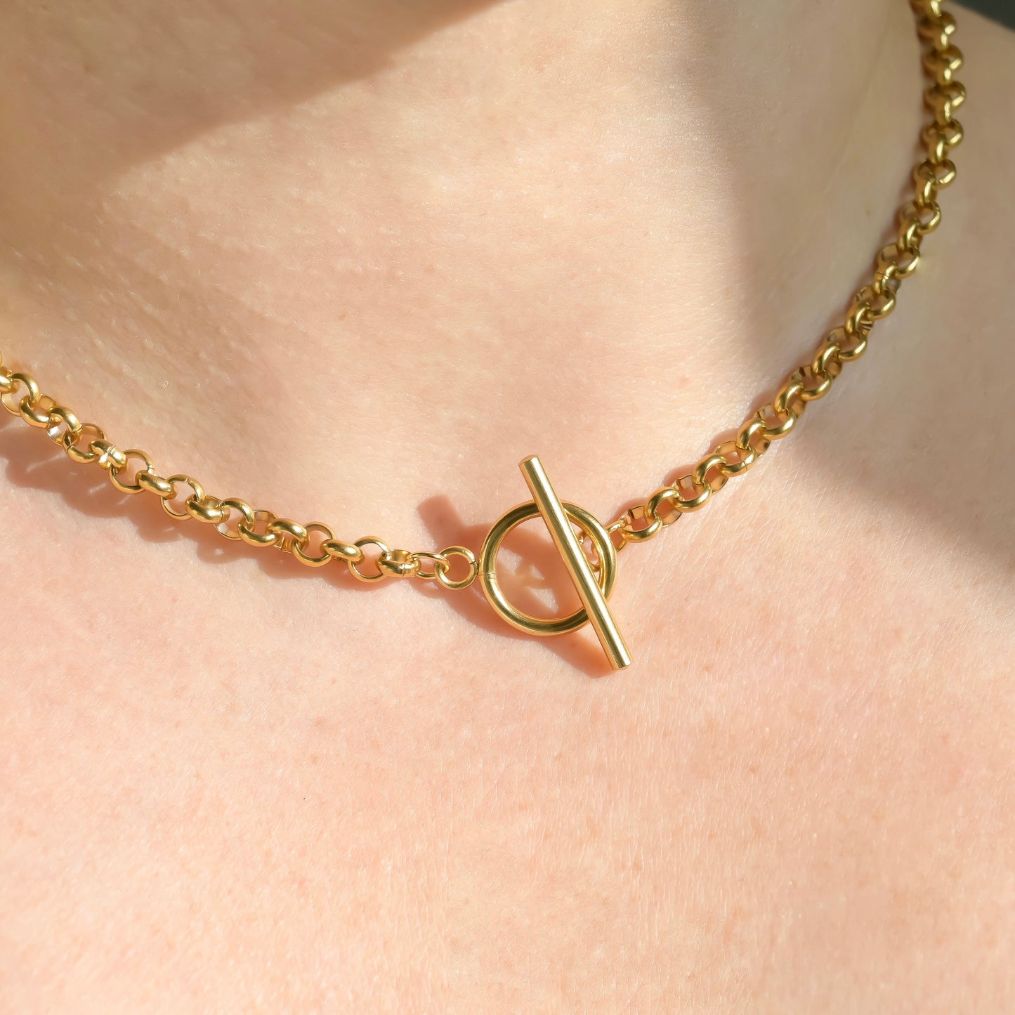 front view of gold OT clasp chain necklace with a clasp on a person's neck