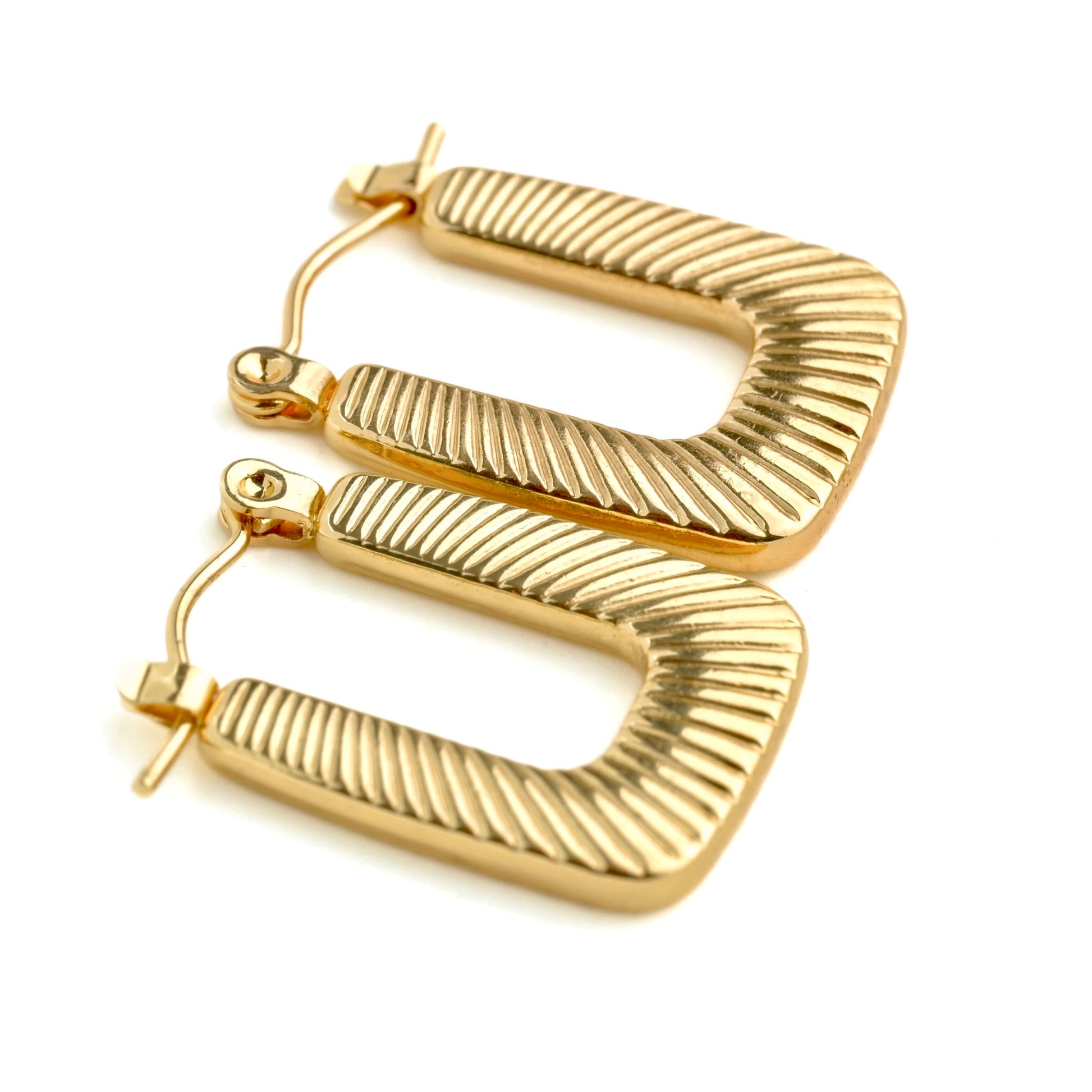 side view of U earrings on a white background