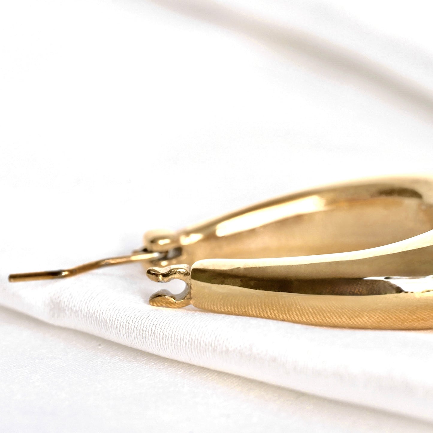 Close-up view of latch back closure of the teardrop hoop earrings