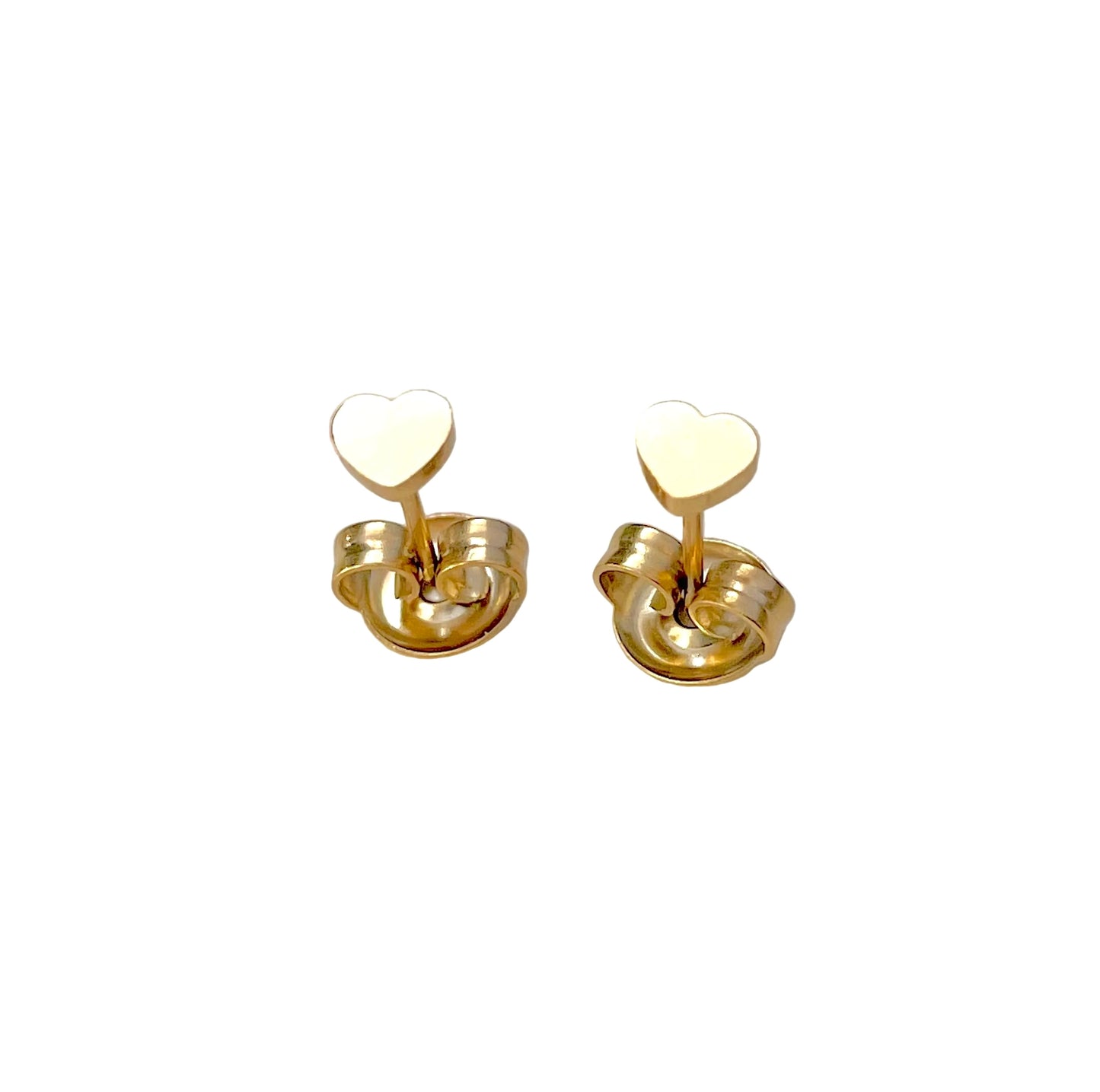 Top view of gold heart stud earrings on butterfly backs on a white background