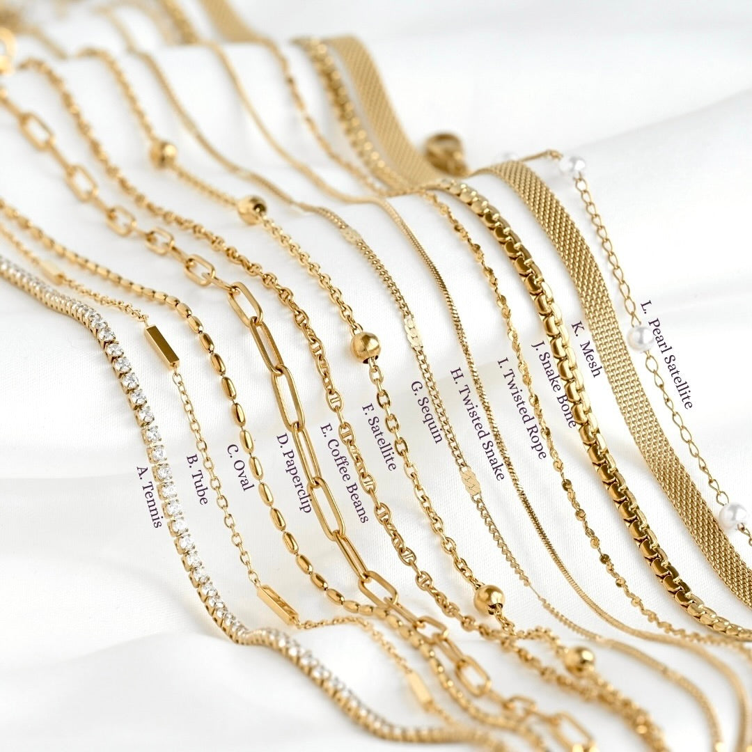 Collection of gold necklaces with various designs on a white background