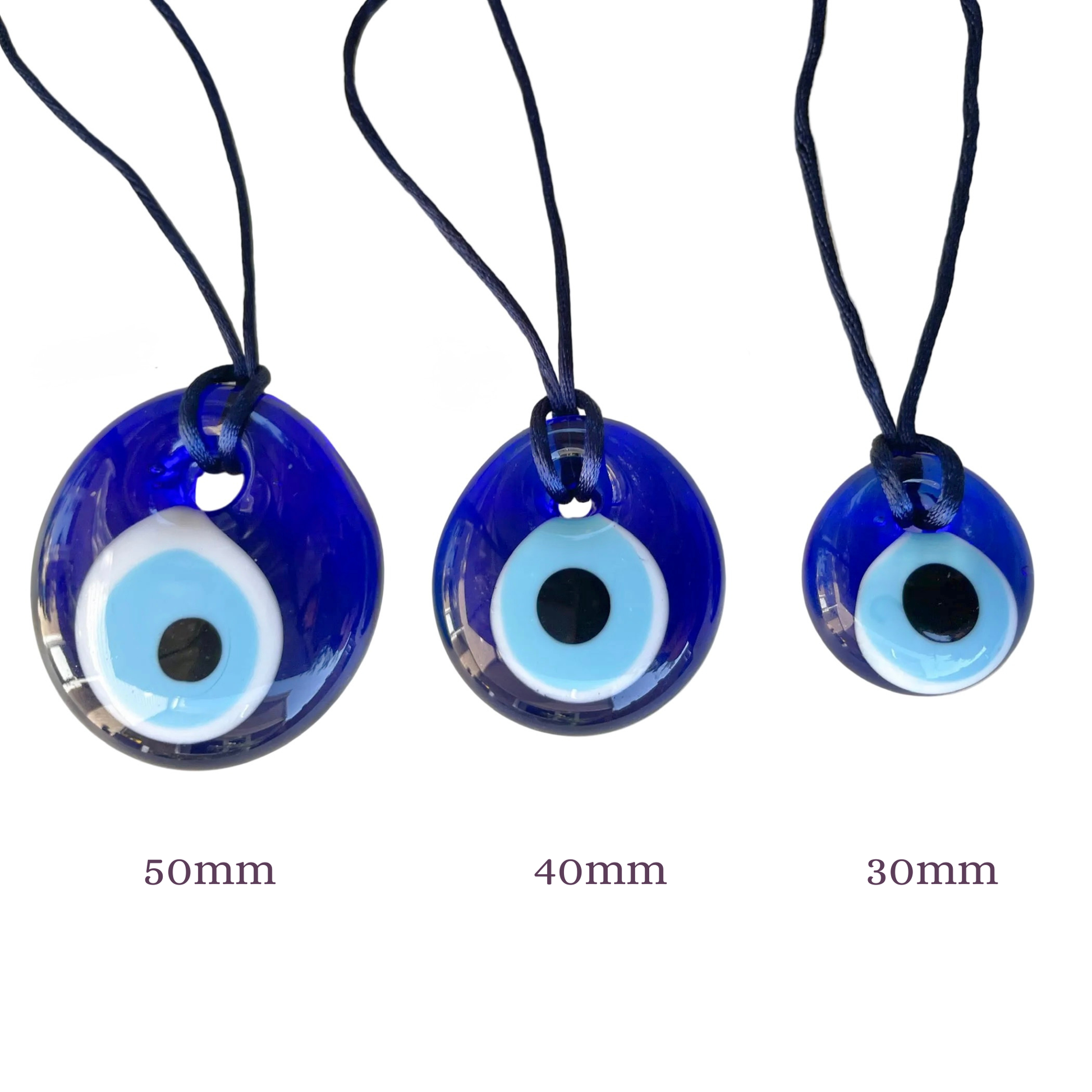 Three blue evil eye amulets with size labels ' 50mm,on a white background' '40mm', and '30mm' on a white background