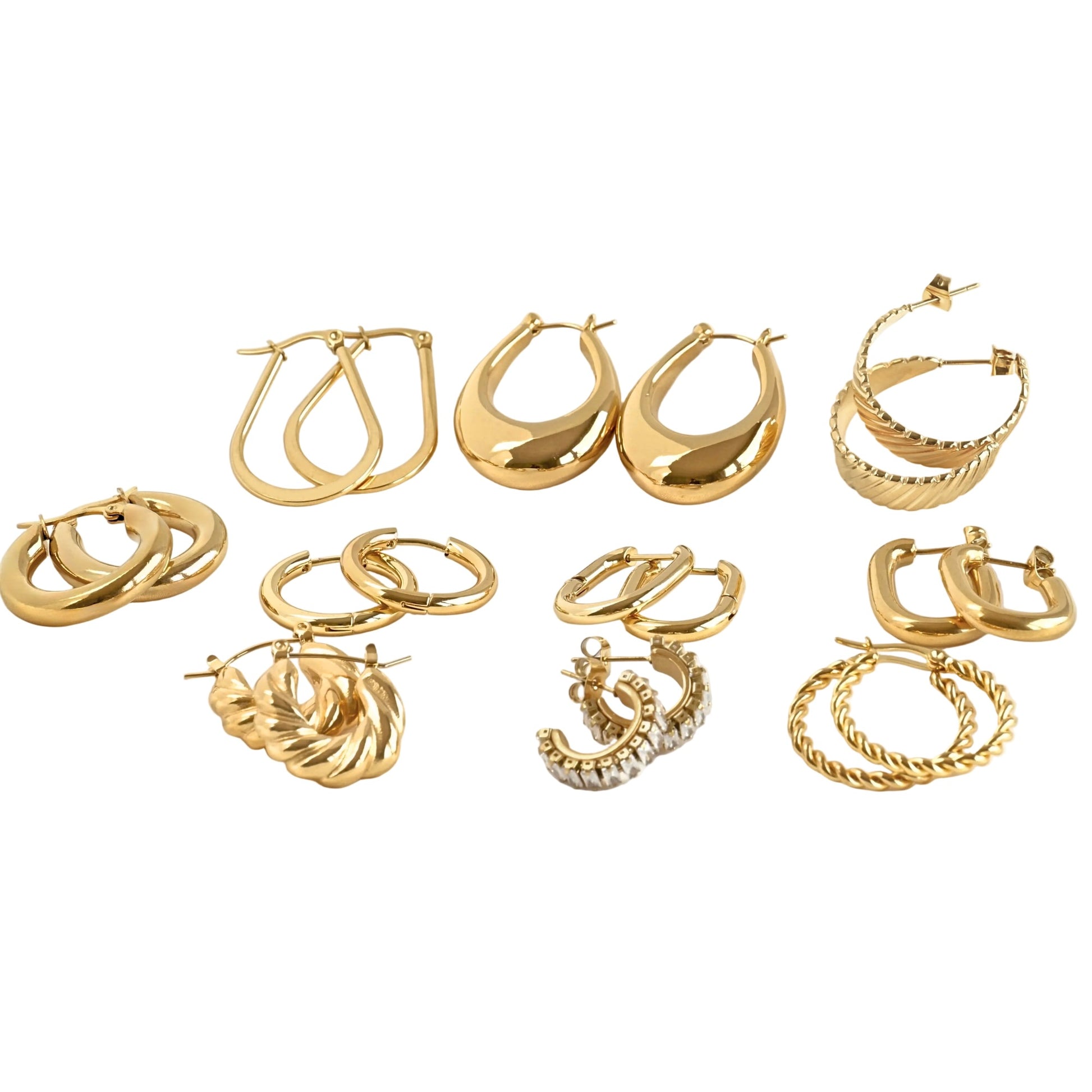 Set of gold hoop earrings on a white background