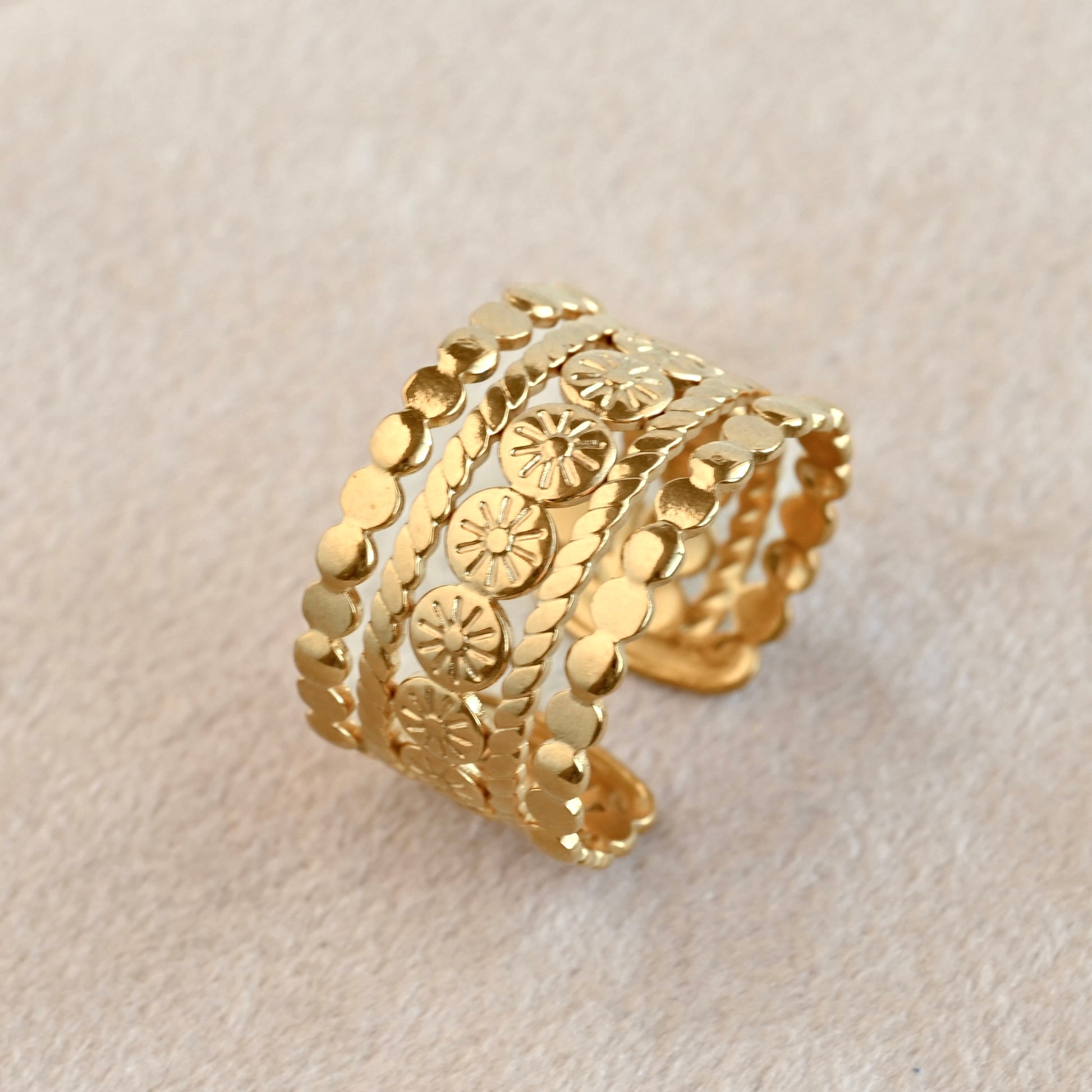 Boho ring with sun patterns on a beige background