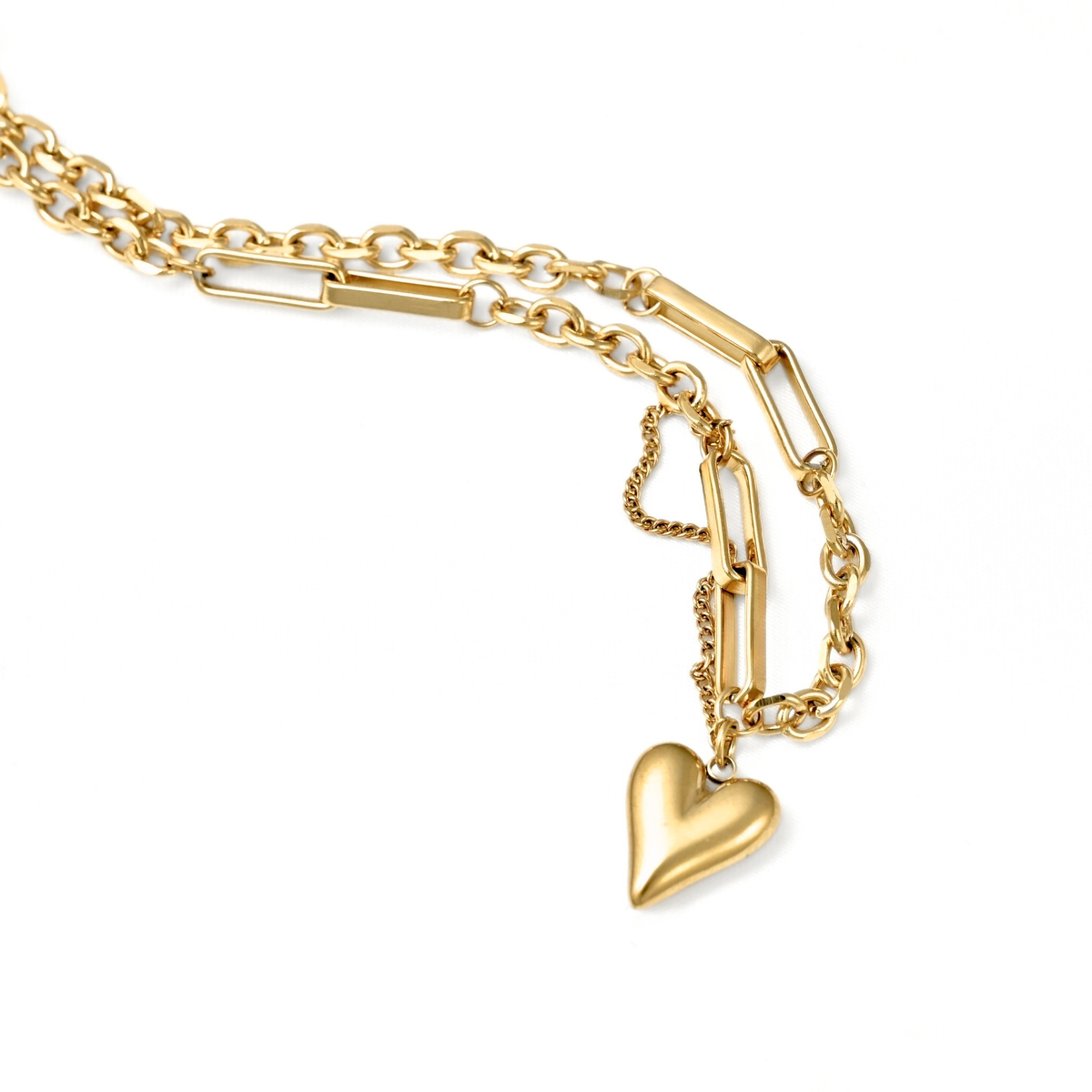 A gold-toned chain necklace featuring a polished heart-shaped pendant, displayed on a clean white background.
