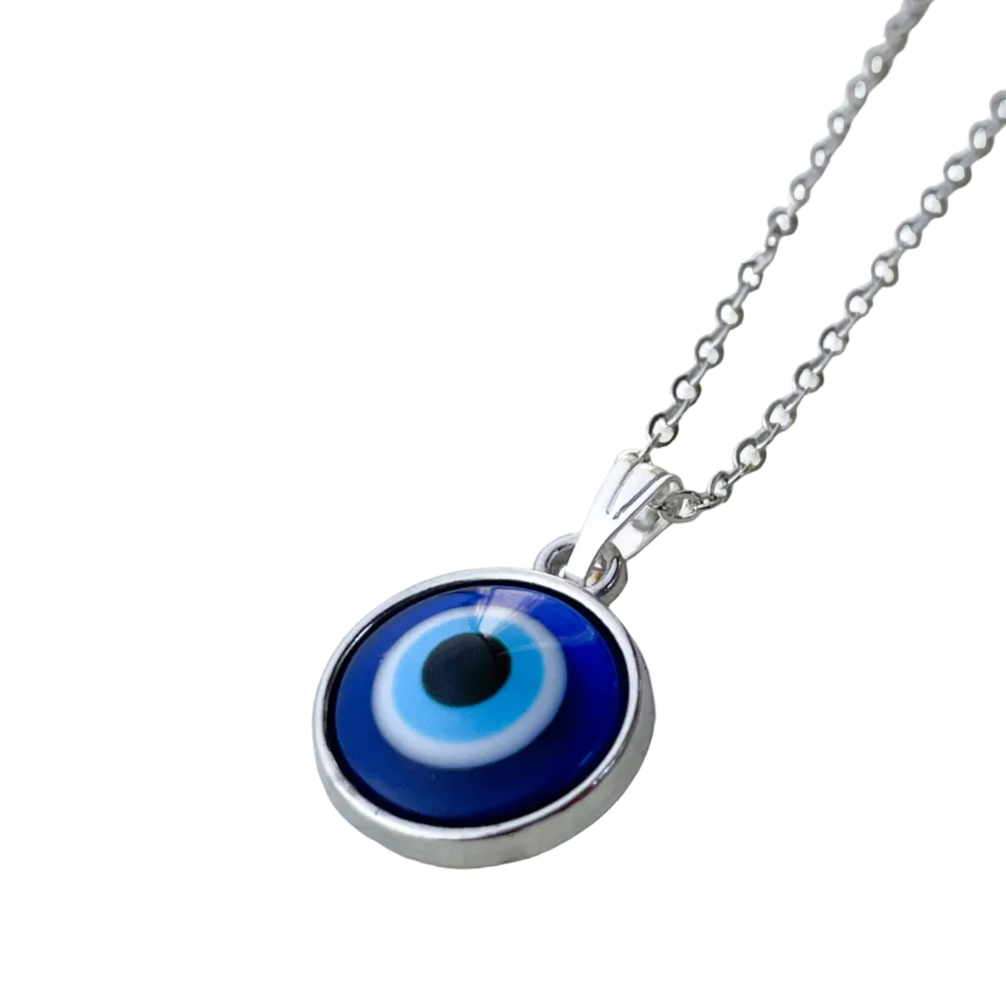 Close-up view of necklace with a blue evil eye pendant on a white background