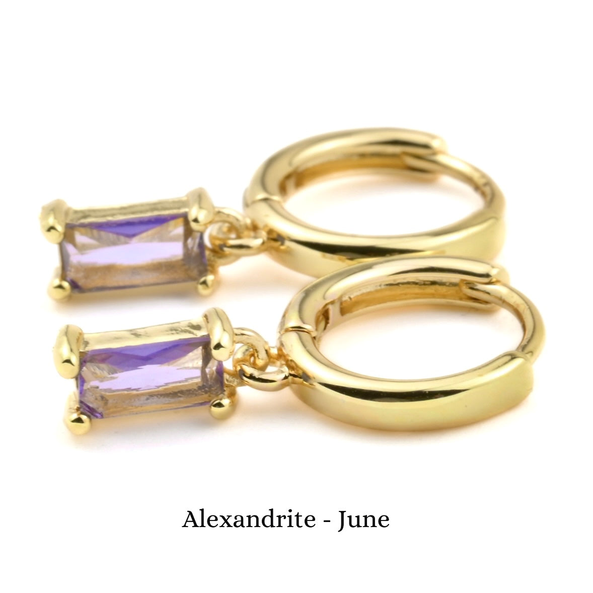 Gold hoop earrings with purple gemstones on a white background, labeled 'Alexandrite - June'.