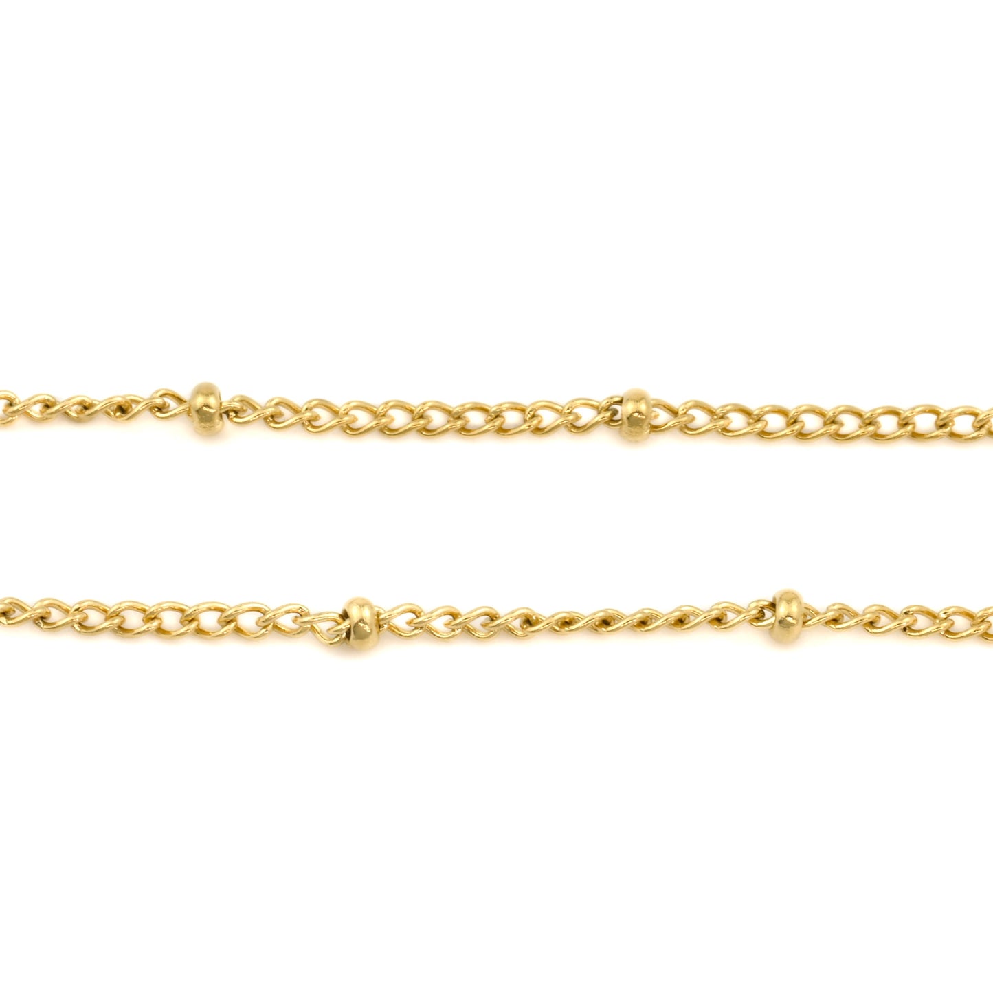 Close up view of Two gold beaded chains on a white background