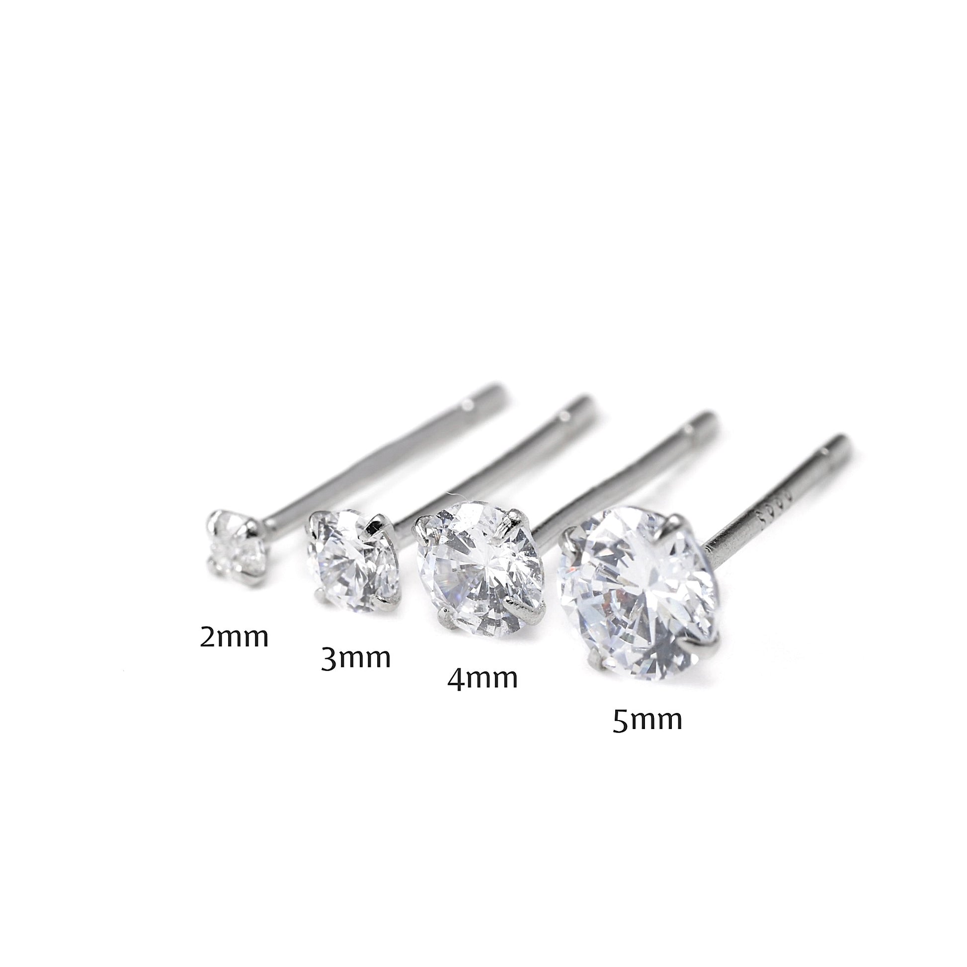 Set of four silver stud earrings with varying diamond sizes, 2 to 5mm, on a white background
