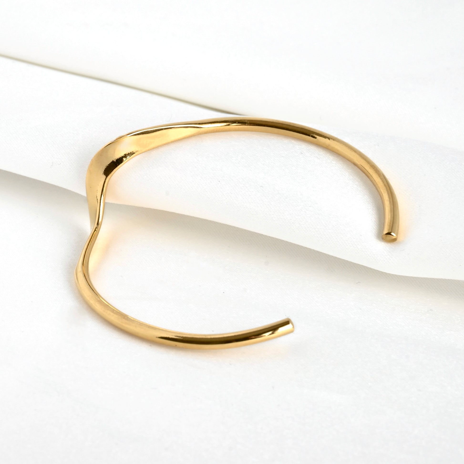 Gold cuff bracelet with an open back