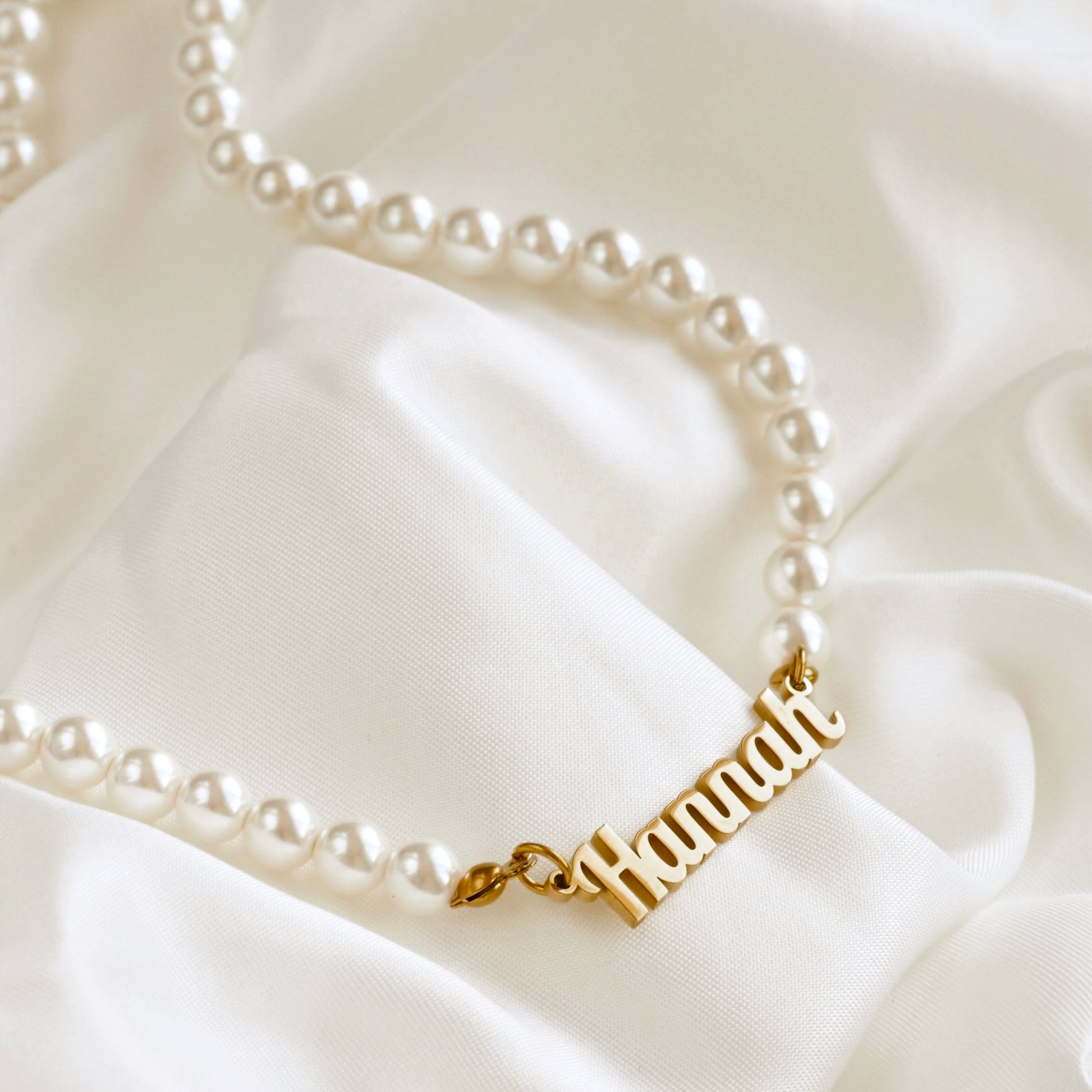 Shell Pearl necklace with 'Hannah' on a white satin background