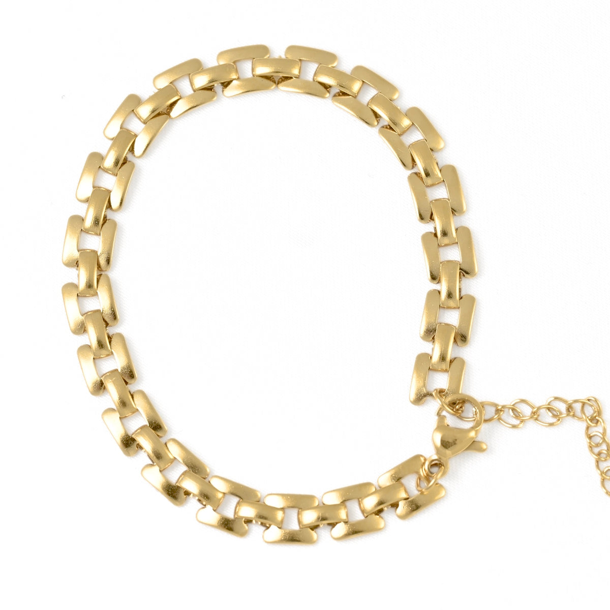 Gold watch-band like chain bracelet on a white background